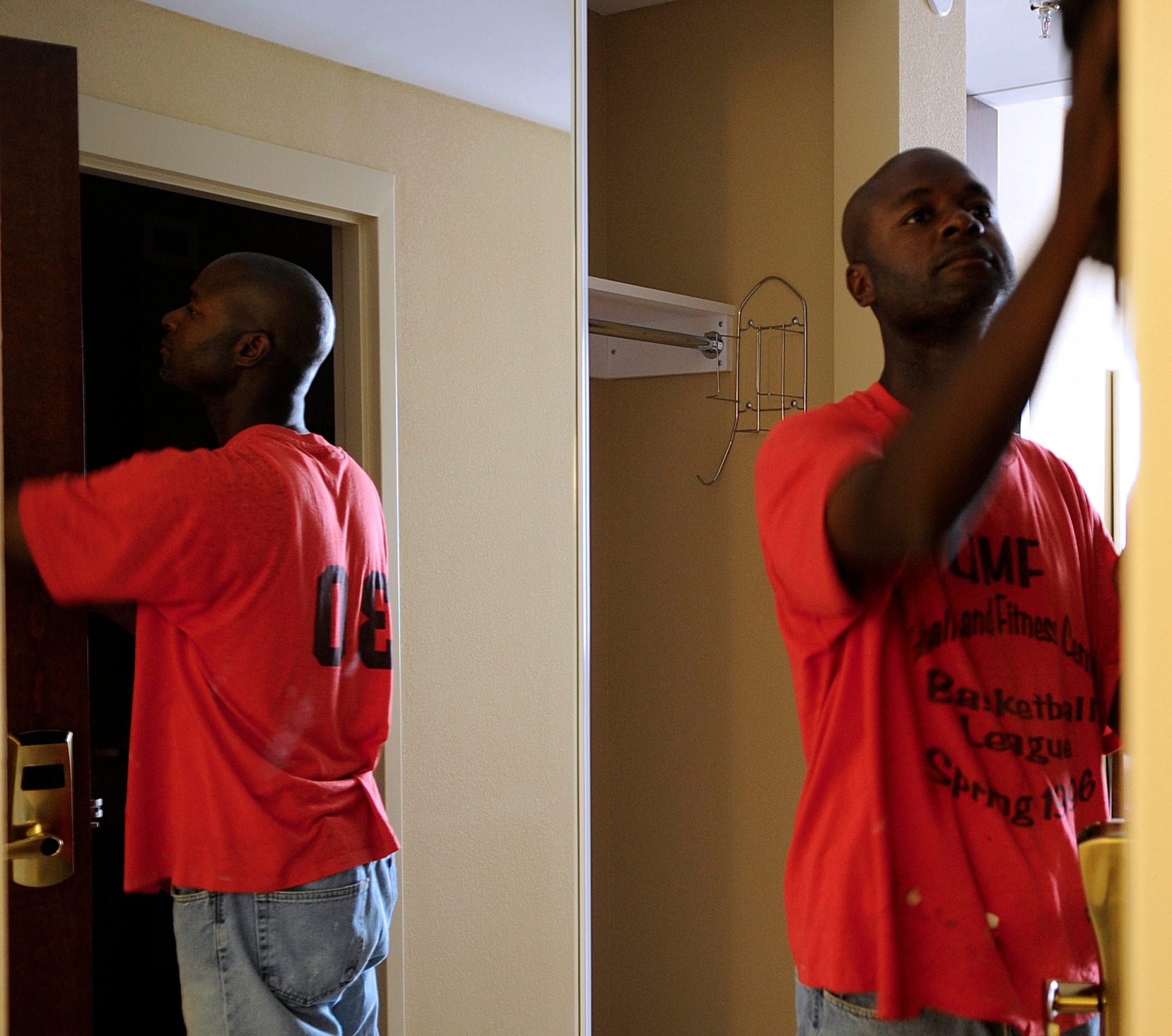 Demetrius Hawthorne, contractor, puts finishing touches onto a room?s door at the new Langley Inn visitor?s quarters at Langley Air Force Base, Va., July 29, 2011. Langley Inn will have different amenities for guess to include a cyber caf? with internet, laundry rooms on each floor and a small shop on the first floor. (U.S. Air Force photo by Staff Sgt. Dana Hill/Released)