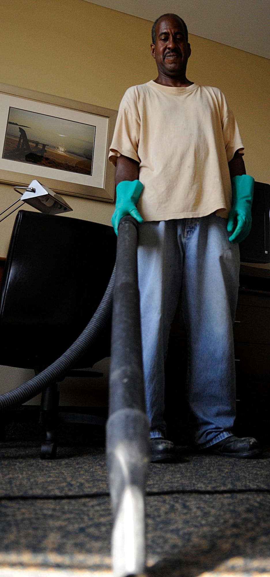 Roosevelt Wilson, contractor, cleans up dust and debris at the new Langley Inn visitor?s quarters at Langley Air Force Base, Va., July 29, 2011. The new Langley Inn will dramatically improve the quality of life for Langley Airmen, their families and visitors. (U.S. Air Force photo by Staff Sgt. Dana Hill/Released)