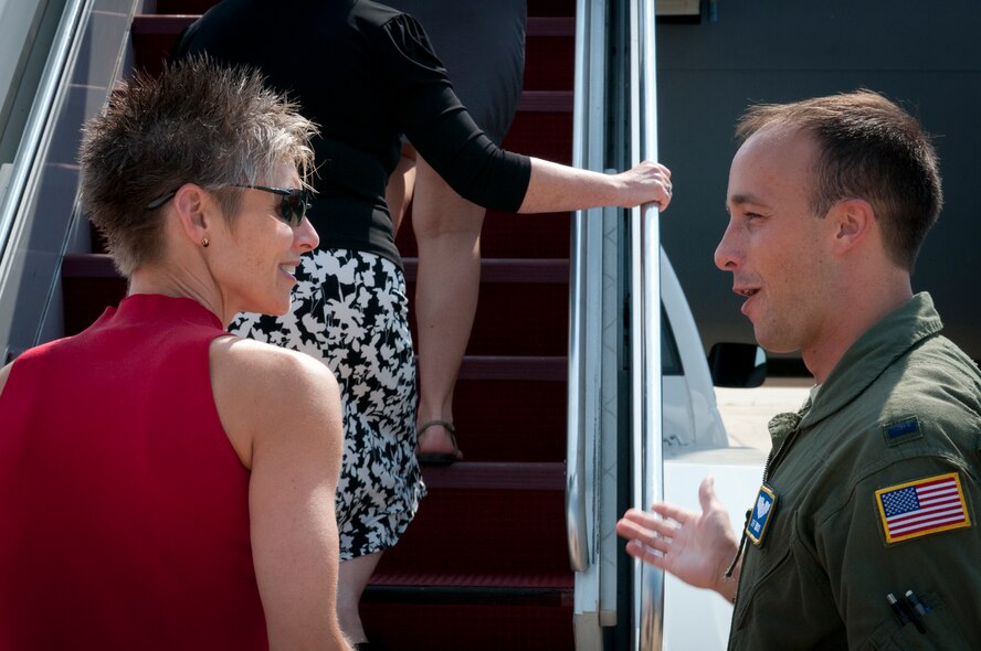 JOINT BASE ANDREWS, Md. – 1st Lt. Jeffrey Mnich, 756th Air Refueling Squadron pilot, welcomes spouses of DoD leaders aboard a KC-135 Stratotanker during a tour here, July 28, 2011. The KC-135 tour was part of a Senior Leader Orientation Course held in Washington, D.C. during the past week.  (U.S. Air Force photo/Tech. Sgt. Steve Lewis)