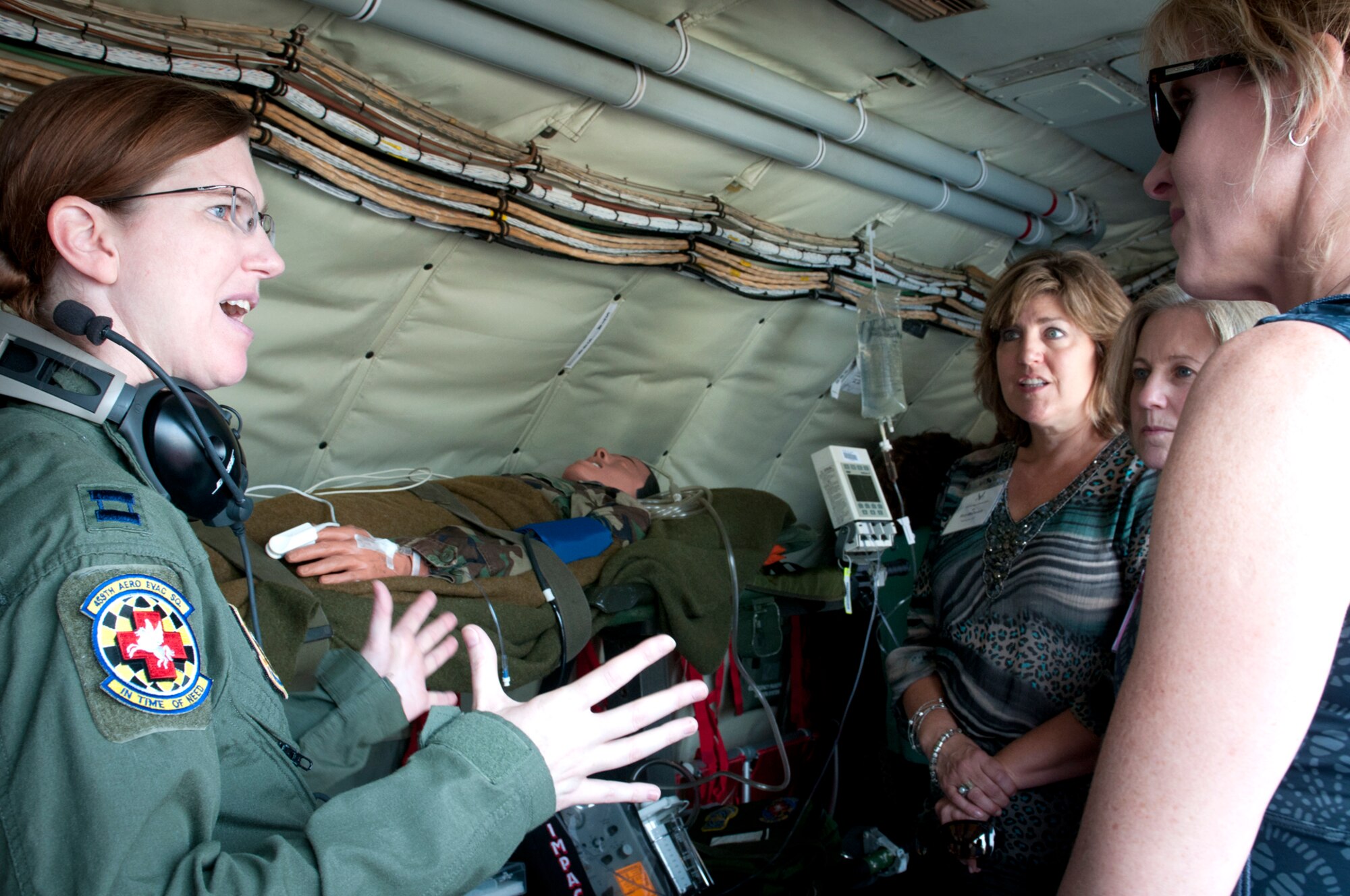 JOINT BASE ANDREWS, Md. -- Capt. Kathleen Cline, 459th Aeromedical Evacuation Squadron flight nurse, describes how the Patient Support Pallet is used aboard a KC-135 Stratotanker to spouses of DoD senior leaders during a tour here, July 28, 2011. The KC-135 tour was part of a Senior Leader Orientation Course held in Washington, D.C. during the past week.  (U.S. Air Force photo/Tech. Sgt. Steve Lewis)