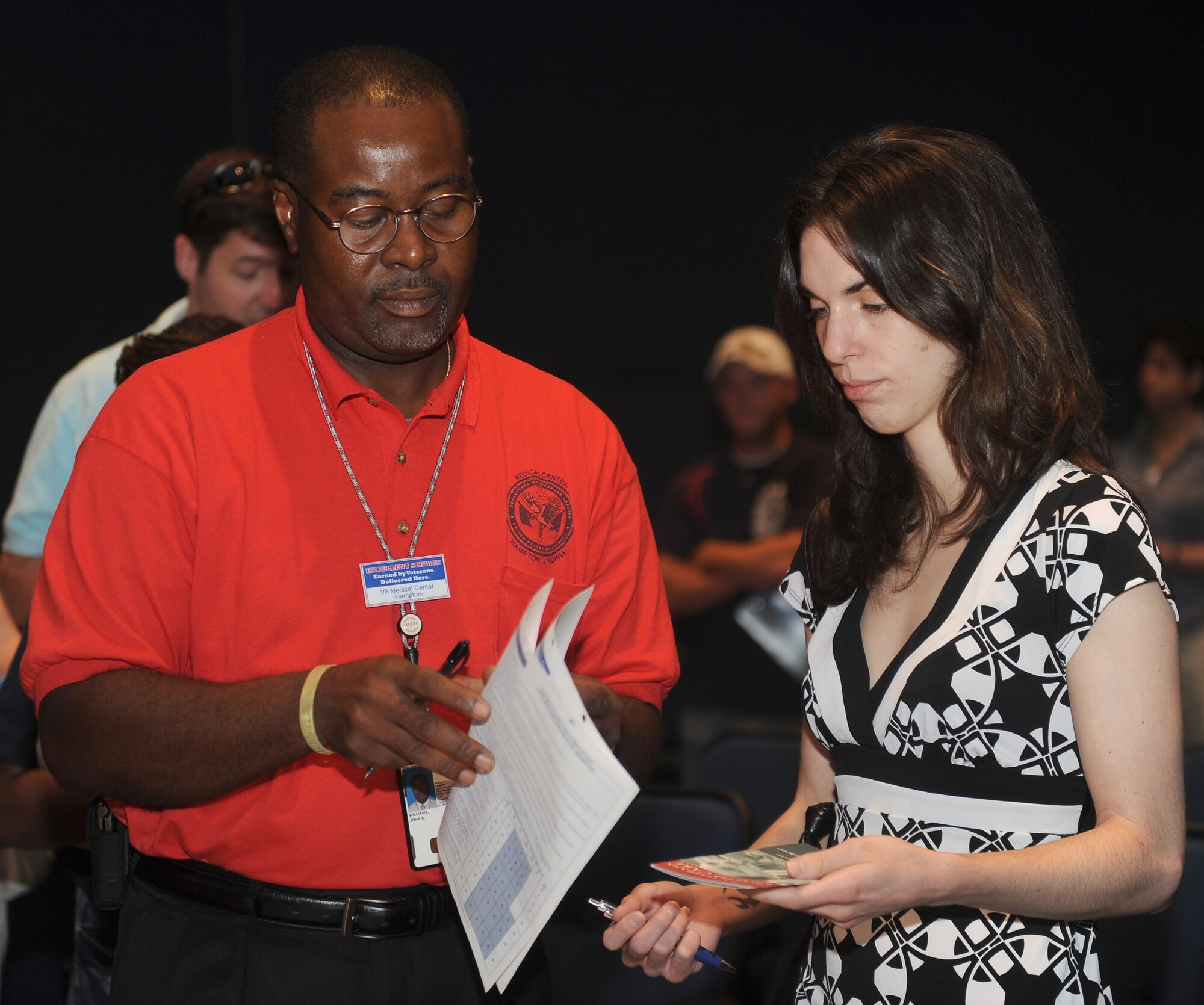 John Williams, Hampton Veterans Health Administration social work case manager, advises Mary Winter of the veteran benefits available to her during the Individual Ready Reserve (IRR) Muster at Langley Air Force Base, Va., July 29, 2011. The IRR Muster Program, created and maintained by the Air Reserve Personnel Center, exists to ensure the Air Force can "reach out and touch" members of the IRR population when called upon to do so. (U.S. Air Force photo by Staff Sgt. Antoinette Gibson/Released)
