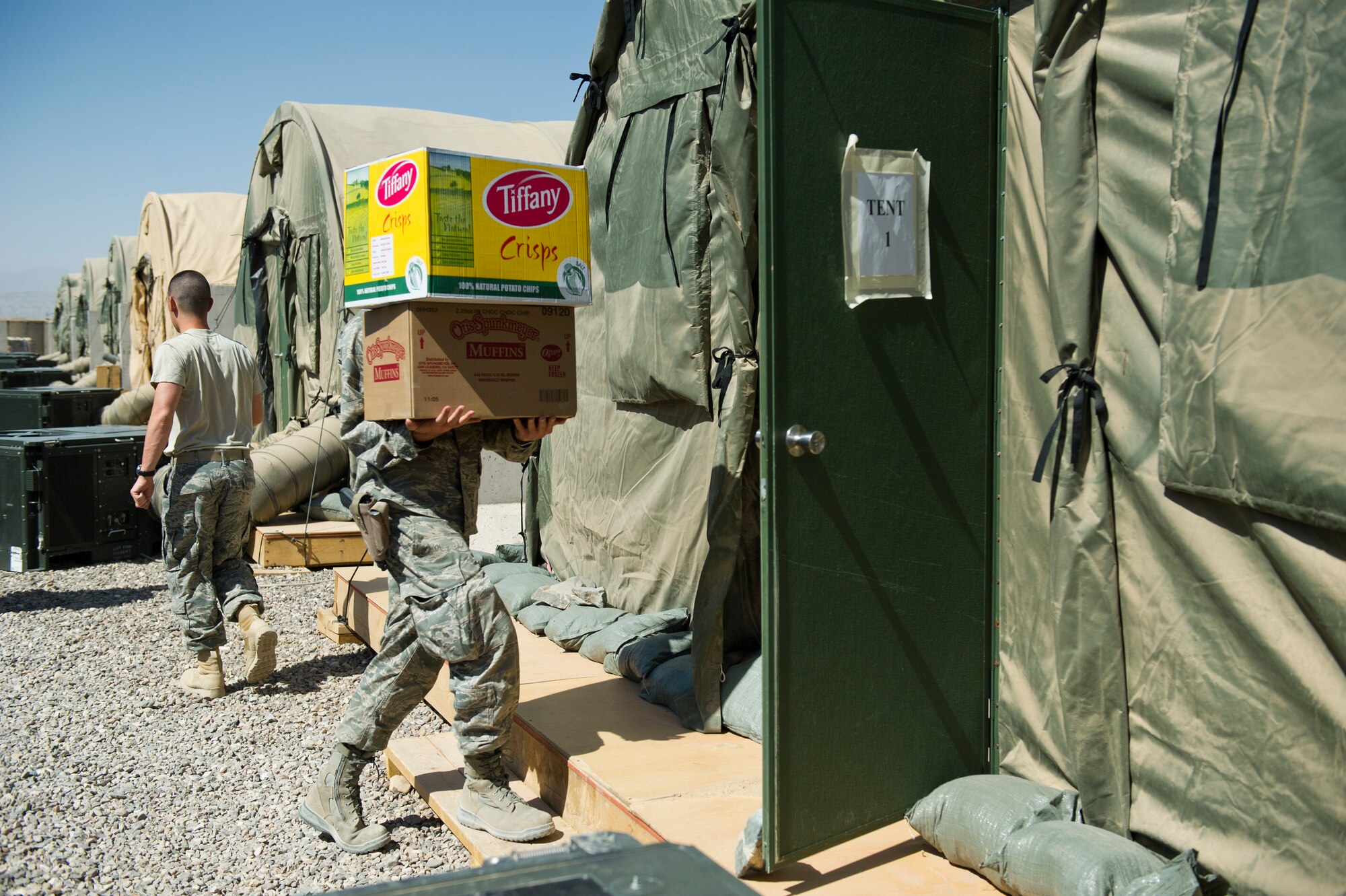 A member of Detachment 1, 73rd Expeditionary Air Control Squadron carries supplies to a storage tent at Camp Etchberger. Isolated from the normal supply chains in Afghanistan, members of the camp must convoy to a nearby base to get supplies and mail.  (U.S. Air Force Photo/Master Sgt. Jeffrey Allen)