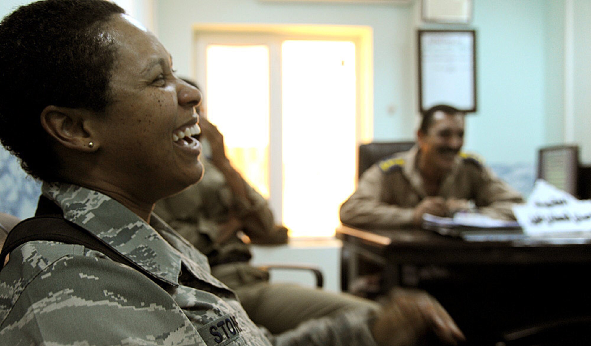U.S. Air Force Tech. Sgt. Toya Stone talks to an Iraqi Air Force officer about their communication abilities and any problems they have been having at Kirkuk Air Base, Iraq. Part of working with the Iraqis is building relationships along with  a level of trust or there could be a chance the Iraqis won't take their advice and get things done. (U.S. Air Force photo by Seniro Airman Tristin English)