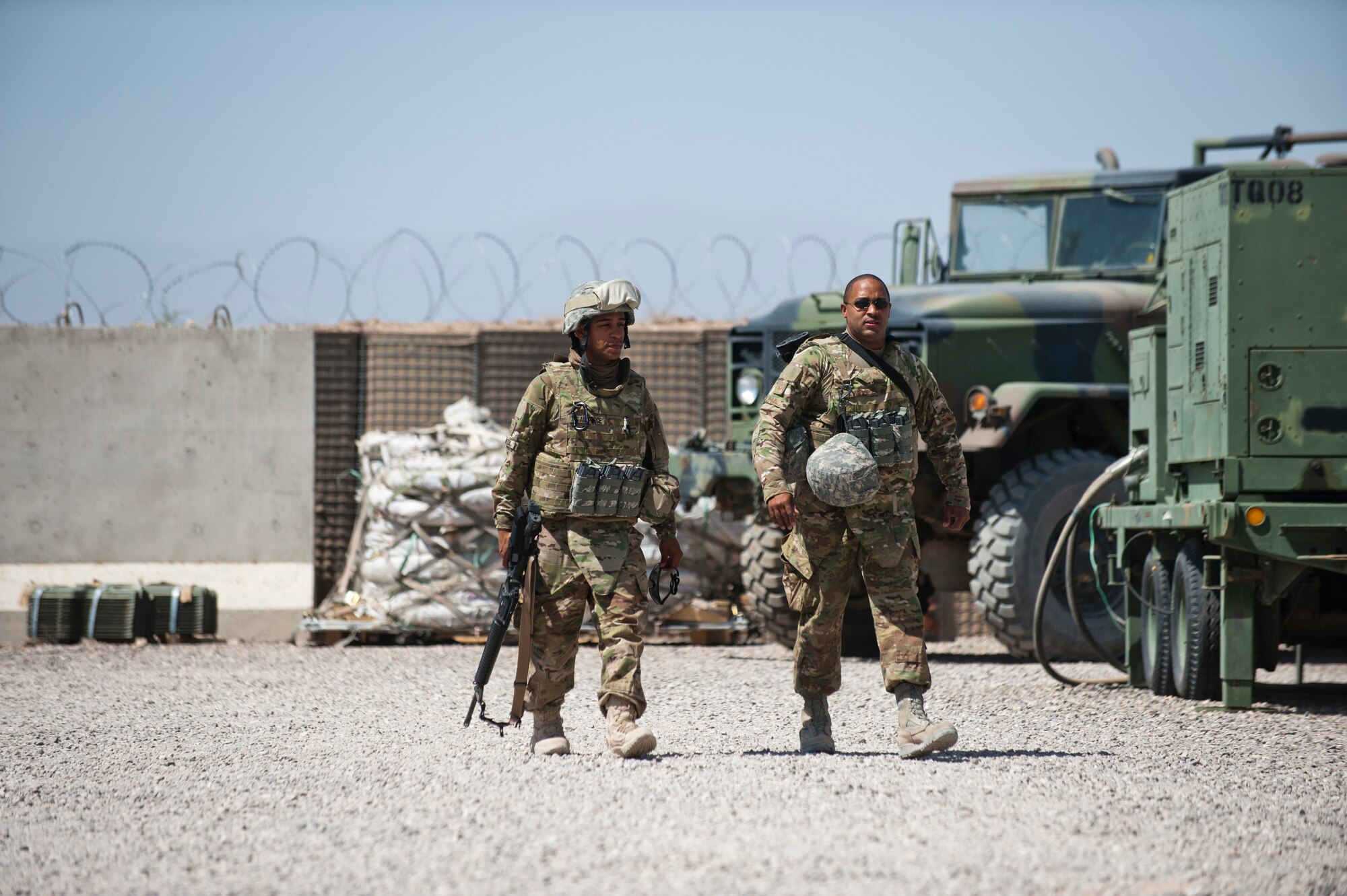 Senior Airman, Johnathan Jweda (left) and Staff Sgt. James Wall of the Detachment 1, 73rd Expeditionary Air Control Squadron walk to their tent after returning from a convoy. The only way the members of the 73rd EACS can receive mail and supplies is to convoy to a larger base nearby. (U.S. Air Force Photo/Master Sgt. Jeffrey Allen)