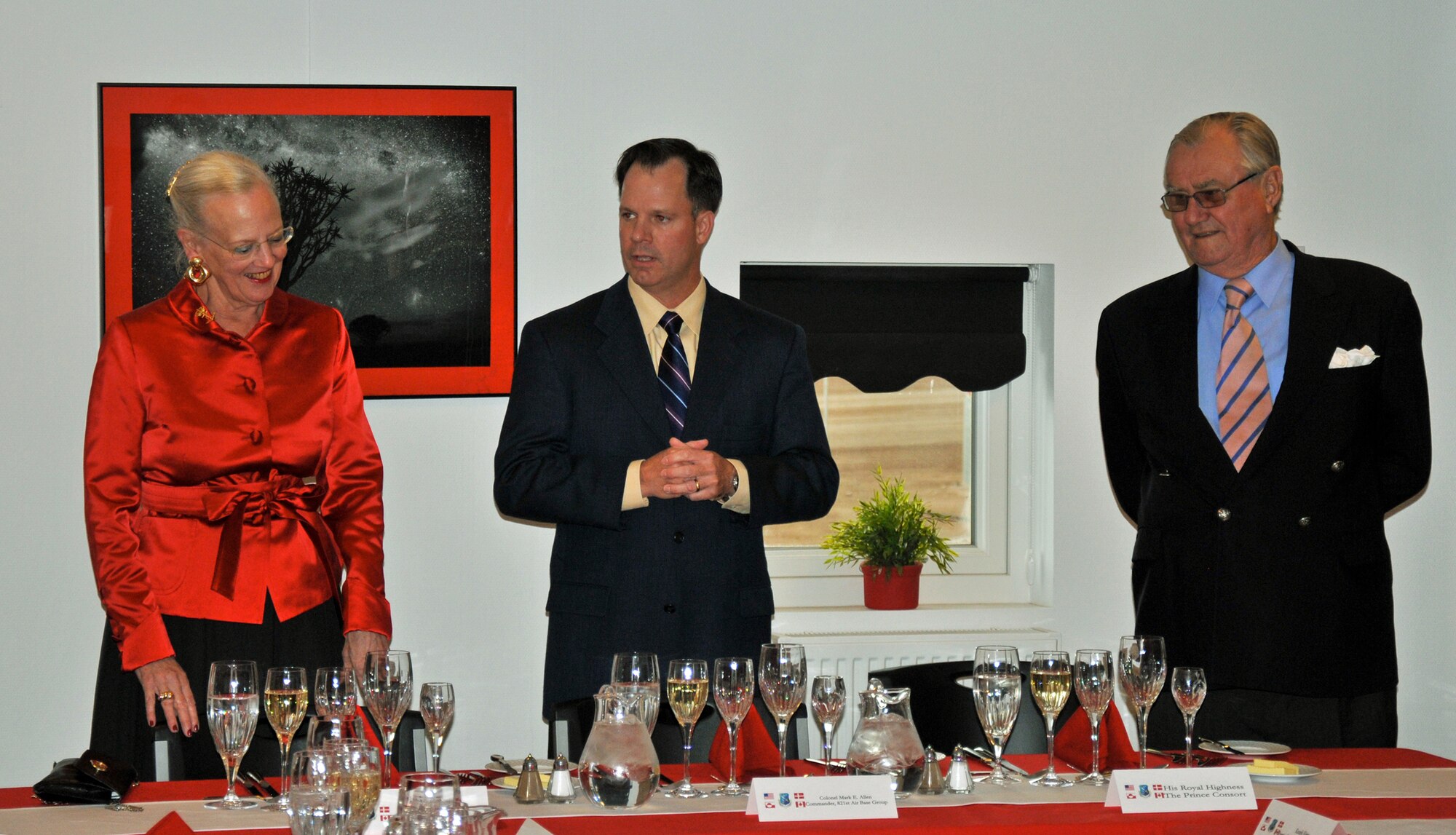 THULE AIR BASE, Greenland – Col. Mark Allen (center), former 821st Air Base Group commander, welcomes Denmark's Queen Margrethe II (left) and the queen's consort Prince Henrik (right), to Thule AB during a formal dinner July 10, 2011. Greenland is part of the Kingdom of Denmark, and the queen’s visit is part of her Greenlandic tour of the region. Thule AB, part of the 21st Space Wing, is the U.S. Armed Forces' northernmost installation and is home to the northernmost deep water port in the world. (Courtesy photo)