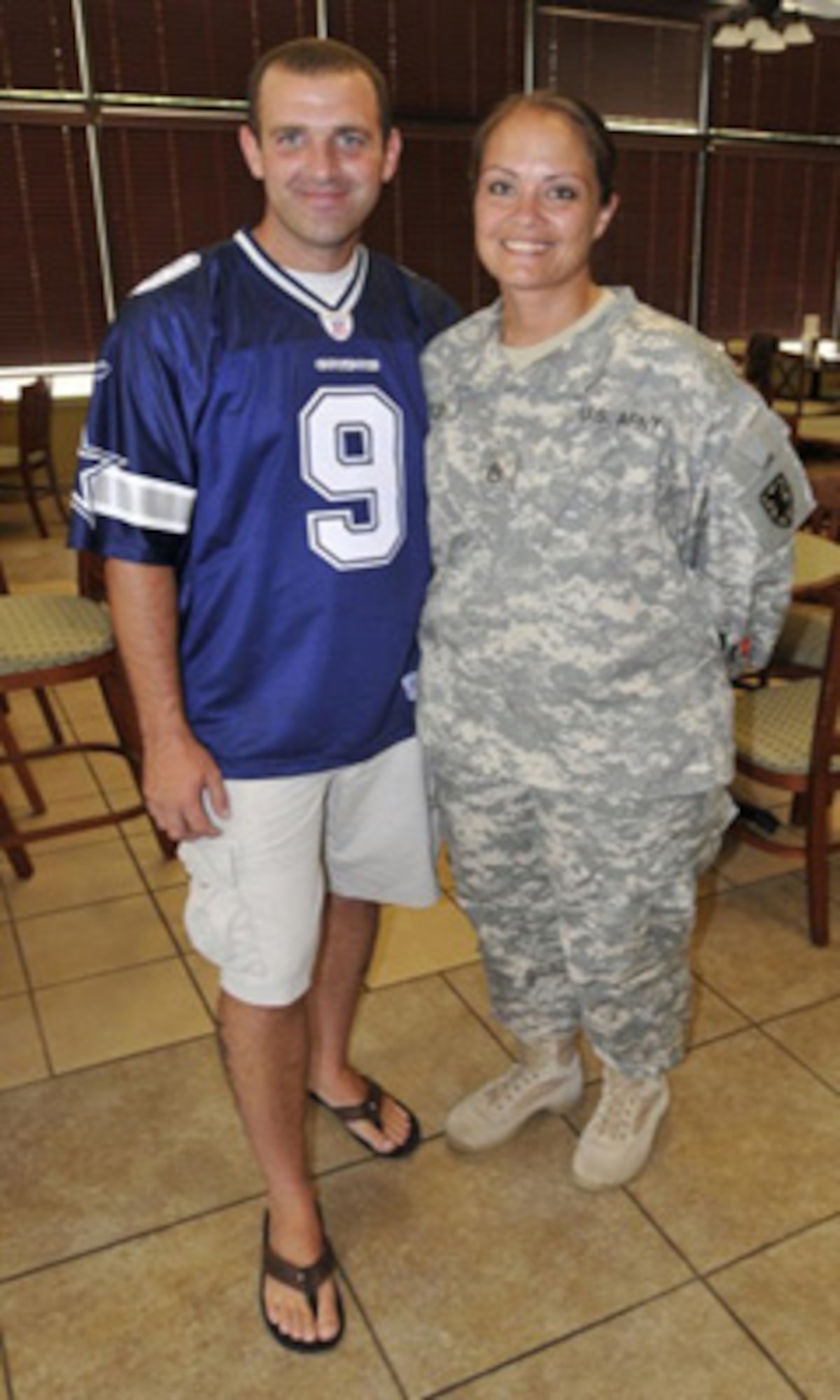 Sgt. 1st Class Stephen Latch (left), 159th Seaport Operations Company, 11th Transportation Battalion, and Staff Sgt. Carmelita Latch, Headquarters and Headquarters Detachment, 11th Transportation Battalion, stand together inside the Lighthouse Café Dining Facility at Joint Expeditionary Base-Fort Story July 22. (U.S. Army photo by Sgt. 1st Class Kelly Jo Bridgwater/Released)