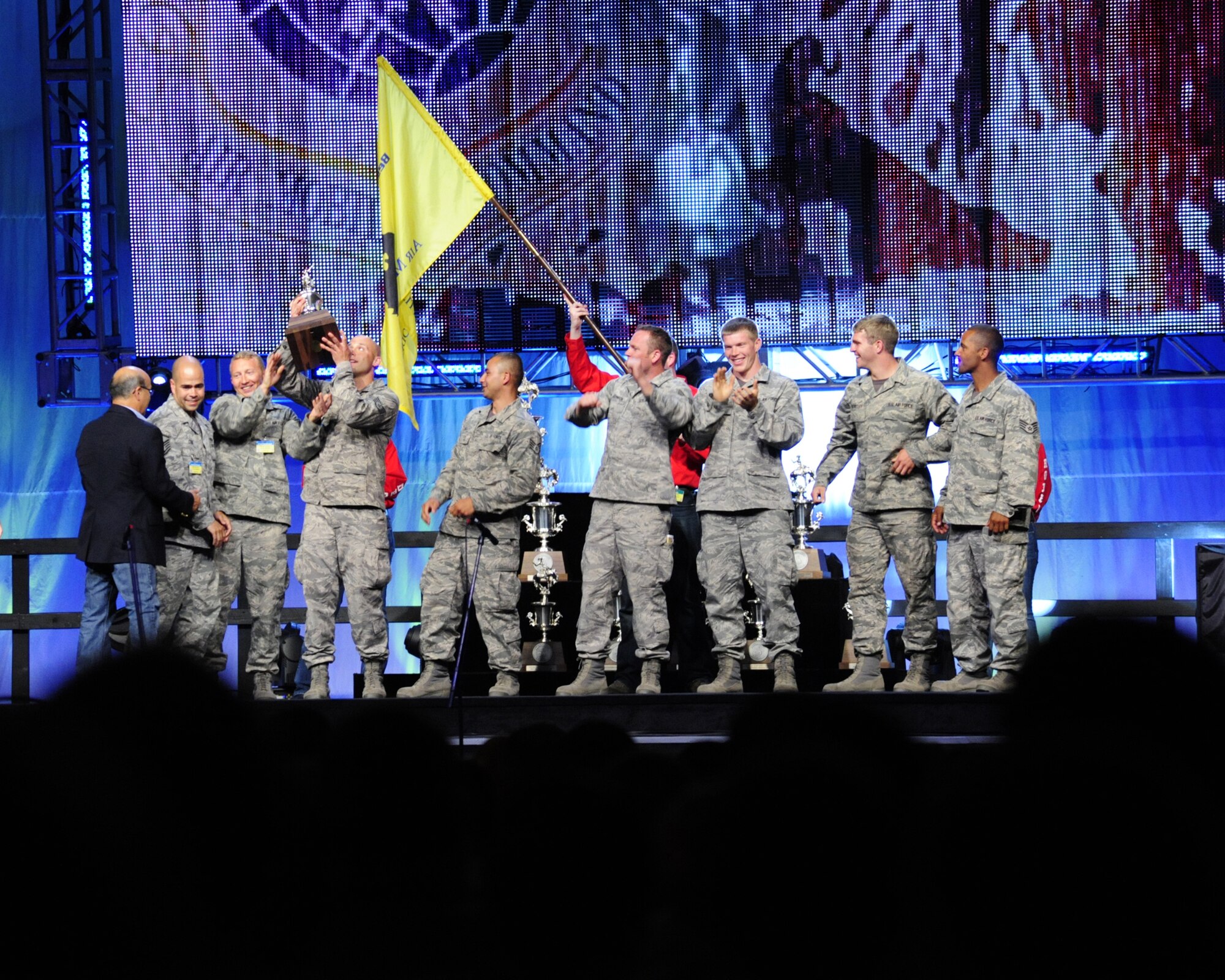 Aerial Port Airmen from the 62nd Airlift Wing and 627th Air Base Group combo team cheer as they receive the trophy for the "Best Aerial Port Team" during the closing ceremony for Air Mobility Rodeo 2011 July 29, 2011, at Joint Base Lewis-McChord, Wash. The group was also named the "Best In-Transit Visibility" team. (U.S. Air Force Photo/Staff Sgt. Frances Kriss)