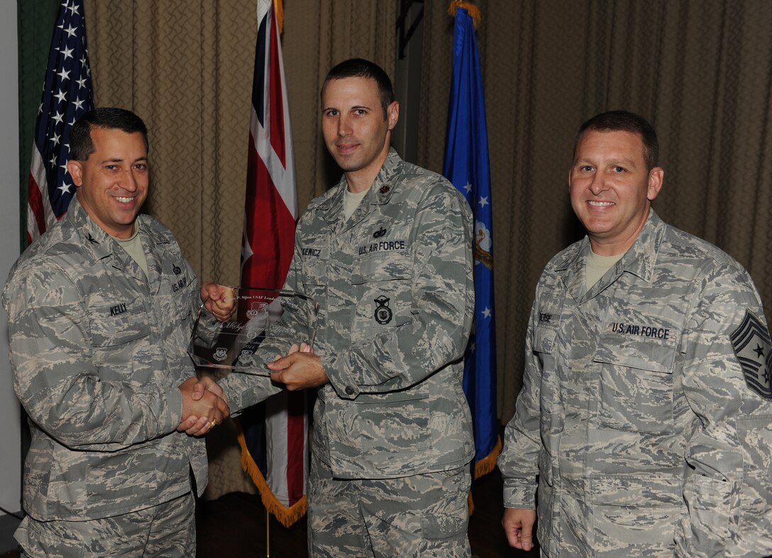 RAF ALCONBURY, United Kingdom - Maj. Erik Dutkiewicz, 423rd Security Forces Squadron, accepts the 501st Combat Support Wing Senior Enlisted Lance P. Sijan Leadership Award on behalf of Senior Master Sgt. Darrin Hooten, 432rd SFS, who was unable to attend. (U.S. Air Force photo by Tech. Sgt. John Barton) 