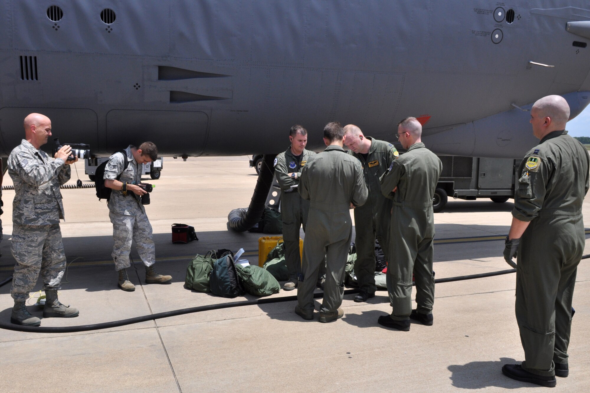 Staff Sgt. Ted Daigle and Senior Airman Chad Warren record images of an 11th Bomb Squadron aircrew preparing for a sortie at Barksdale Air Force Base, La., July 26, 2011.  The 11th BS aircrew was participating in the 2011 Global Strike Challenge. The competition, which is currently underway, includes bases, units and people across the country. The competition will continue through the score-posting and symposium event in November. The competition wraps up with an awards ceremony at Barksdale where trophies will be awarded to the final winners. Daigle, who is assigned to the 307th Bomb Wing Public Affairs office, was recording events to be used during the award ceremonies at the conclusion of the competition. Warren was photographing the event for a news story about the competition. (U.S. Air Force photo/Tech. Sgt. Jeff Walston)