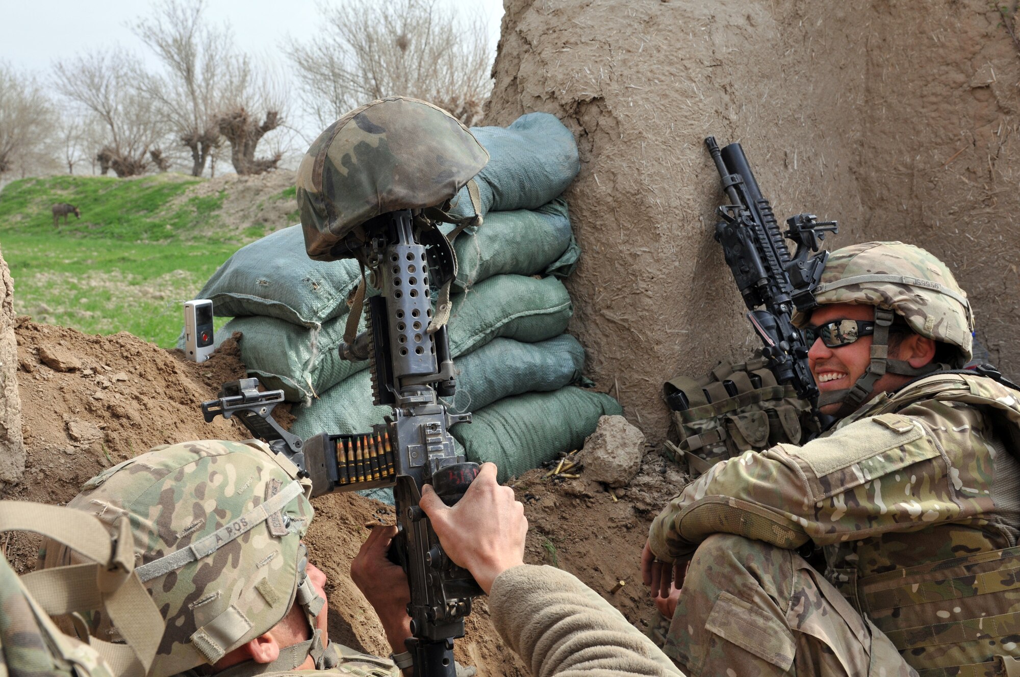 U.S. Army Pfc. Ben Bradley and Sgt. Jeff Sheppard, 7th Squadron, 10th Cavalry Regiment scouts, laugh during a break in fire during a combat engagement in northern Bala Murghab Valley, Baghdis Province, Afghanistan. The scouts redeployed to Fort Carson, Colo., in June and July 2011. (U.S. Air Force photo/Tech. Sgt. Kevin Wallace)