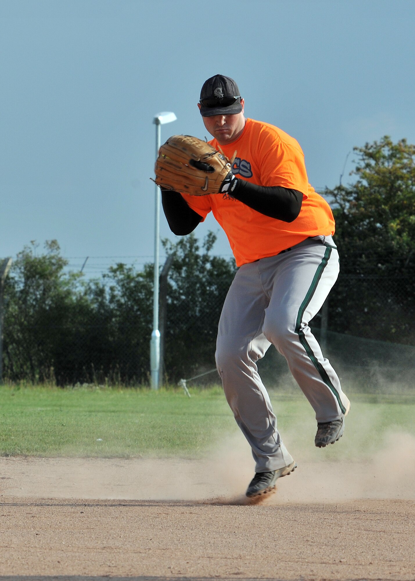 RAF MILDENHALL, England -- Ryan Courtwright, 100th Communication Squadron, prepares to fire the ball to first base during the first game of the 100th Air Refueling Wing intramural softball playoffs here July 28, 2011. The intramural playoffs will run until Aug. 4 and teams are always looking for support from their units in the stands. (U.S. Air Force photo/Staff Sgt. Tabitha M. Lee)    