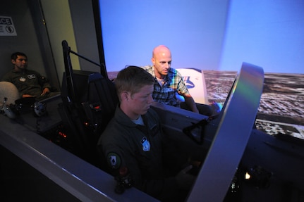 Kevin Coleman (right), 559th Flying Training Squadron T-6 simulator instructor, teaches Air Force Academy Cadet   Cole Vonohlen how to fly the T-6 simulator on Randolph Air Force Base July 15. (U.S. Air Force photo/Rich McFadden) (released)