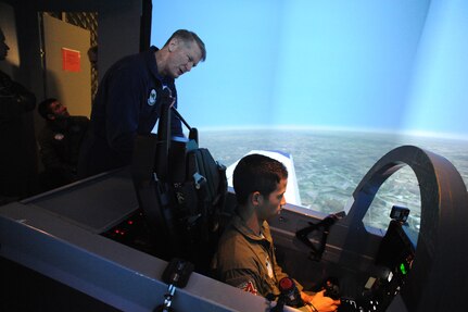 Dana Gunter (left), 559th Flying Training Squadron T-6 simulator instructor, teaches Air Force Academy Cadet   Johnathan Fonbuena how to fly the T-6 simulator on Randolph Air Force Base July 15. (U.S. Air Force photo/Rich McFadden) (released)