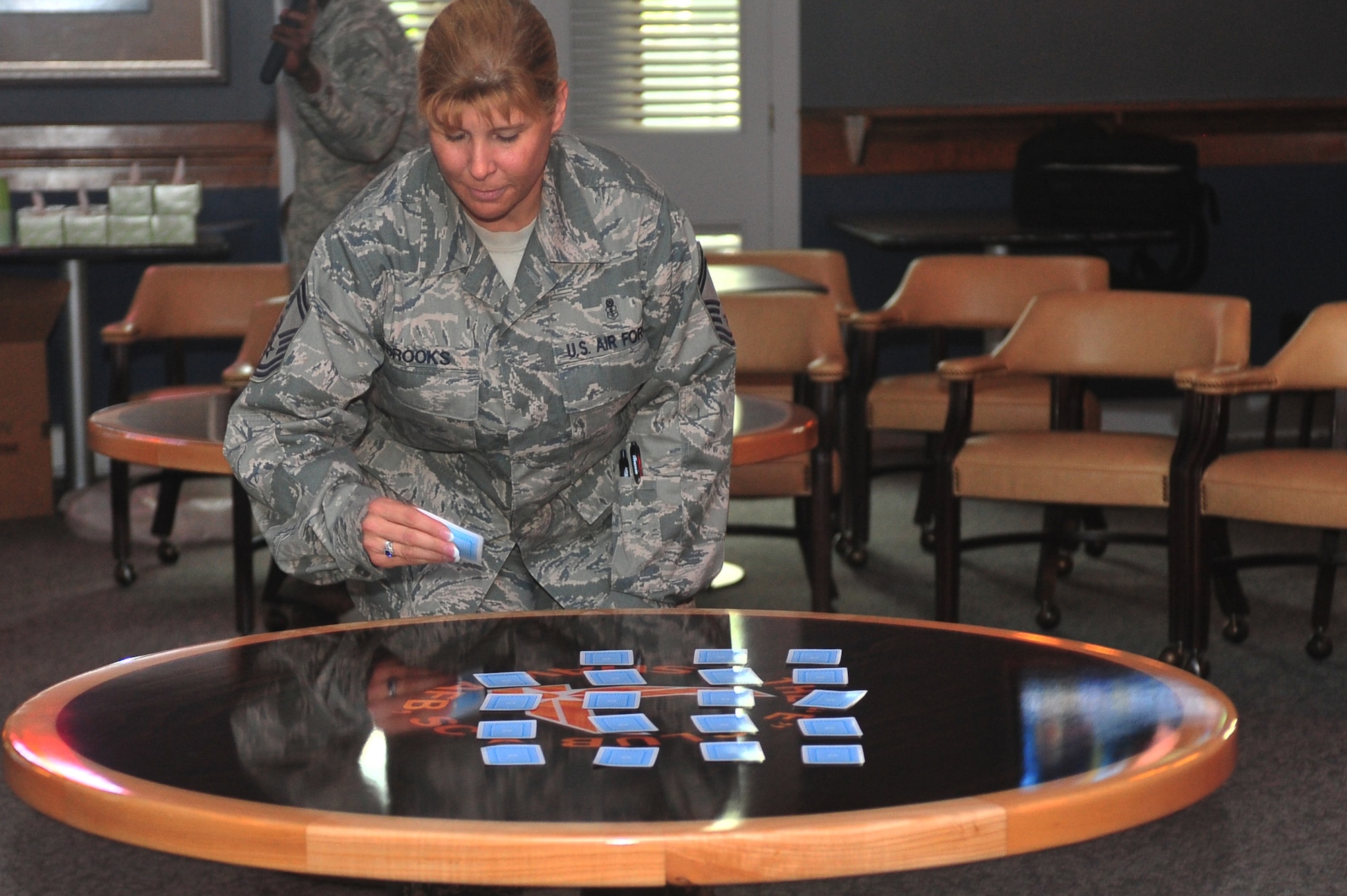 U.S. Air Force Senior Master Sgt. Robin Brooks, Medical Support Squadron superintendent, gets involved in a “Minute to Win It” competition, as the race with cards begins, Shaw Air Force Base, S. C. July 20, 2011. The “Minute to Win It” competition brought Airman together and showcased squadron’s teamwork. (U.S. Air Force photo by Airman 1st Class Ashley Gardner/ Released)