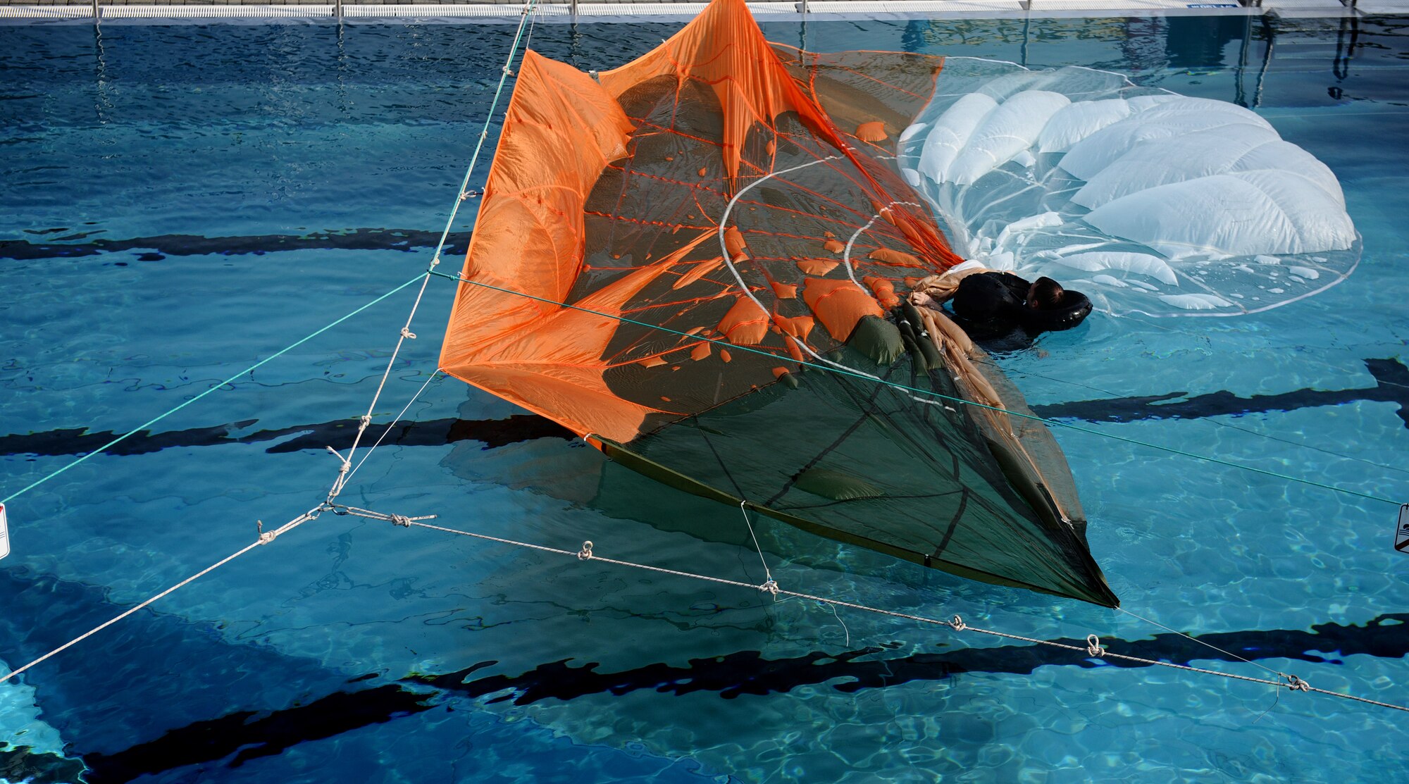 SPANGDAHLEM AIR BASE, Germany -- Capt. Bennett Merriman, 81st Fighter Squadron A-10 Thunderbolt II pilot, removes himself from under a parachute canopy during water survival training here July 29. Water survival training is a triennial requirement for pilots. (U.S. Air Force photo/Staff Sgt. Nathanael Callon)