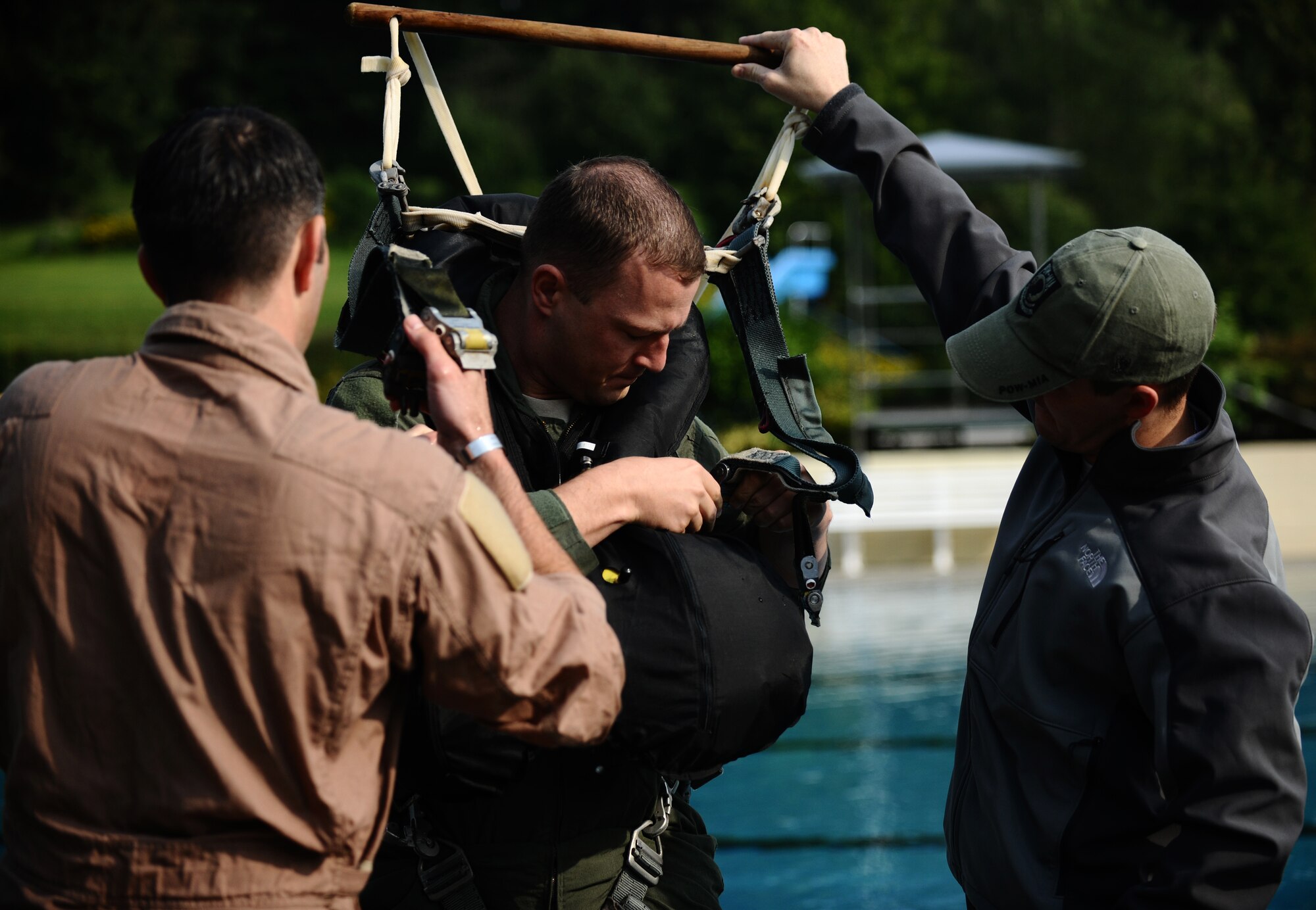 SPANGDAHLEM AIR BASE, Germany -- Maj. Jim Stokman, 81st Fighter Squadron A-10 Thunderbolt II pilot, straps himself into a parachute harness during water survival training here July 29. Water survival training is a triennial requirement for pilots. (U.S. Air Force photo/Staff Sgt. Nathanael Callon)