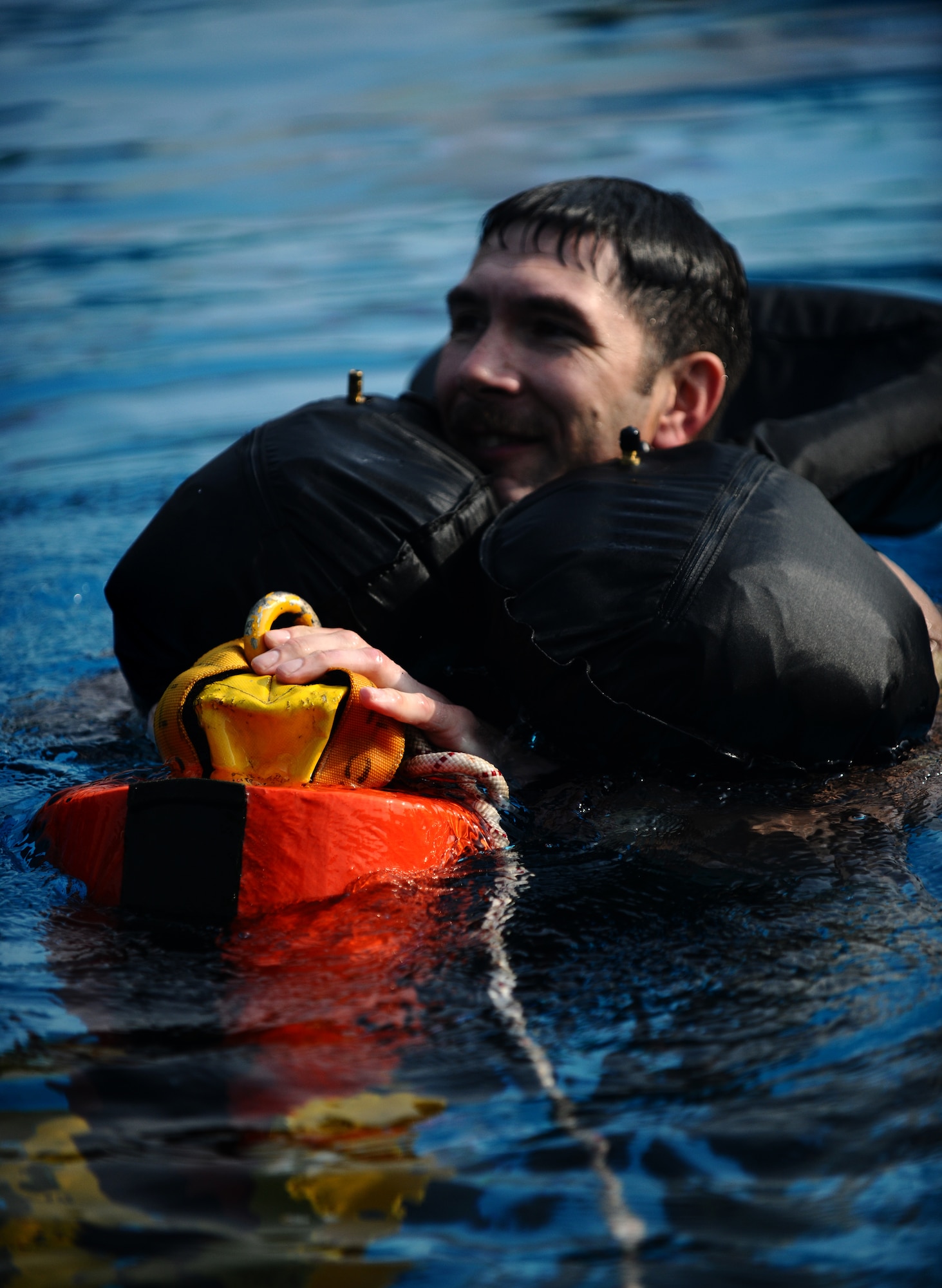 SPANGDAHLEM AIR BASE, Germany -- Tech. Sgt. Robert Martin, 52nd Fighter Wing Survival, Evasion, Resistance and Escape Training and Operations Survival NCO in charge, straps himself to a rescue recovery device during water survival training here July 29. Martin demonstrated proper procedures to pilots from the 81st Fighter Squadron who must complete water survival training as part of a triennial requirement. (U.S. Air Force photo/Staff Sgt. Nathanael Callon)