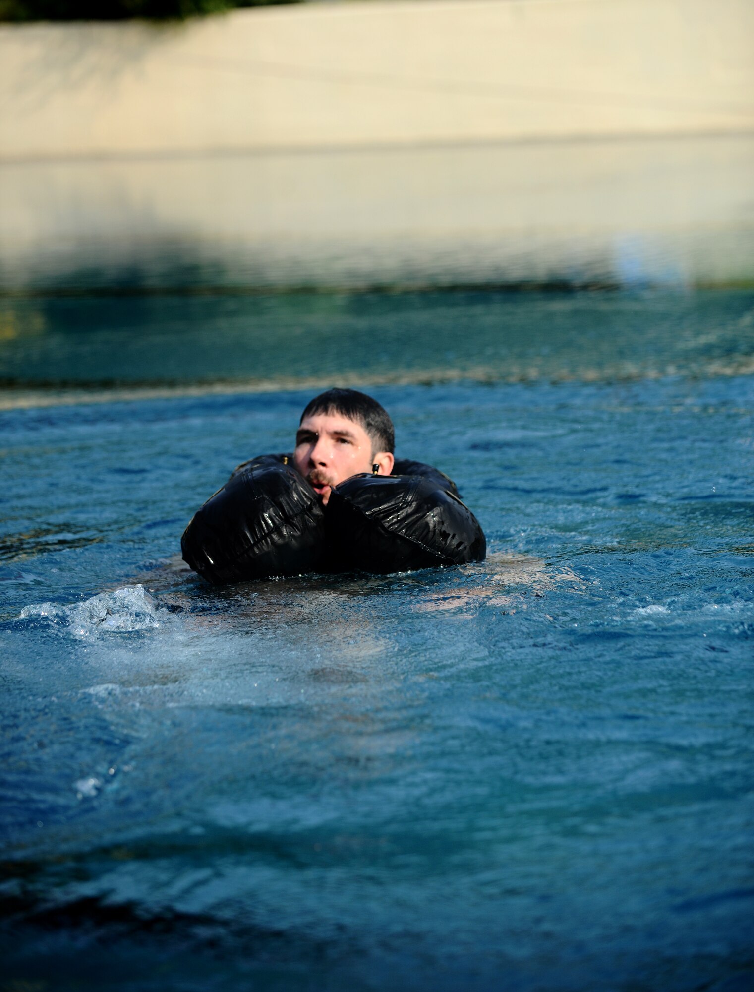 SPANGDAHLEM AIR BASE, Germany -- Tech. Sgt. Robert Martin, 52nd Fighter Wing Survival, Evasion, Resistance and Escape Training and Operations Survival NCO in charge, treads water after disengaging his parachute harness during water survival training here July 29. Martin demonstrated proper procedures to pilots from the 81st Fighter Squadron who must complete water survival training as part of a triennial requirement. (U.S. Air Force photo/Staff Sgt. Nathanael Callon)