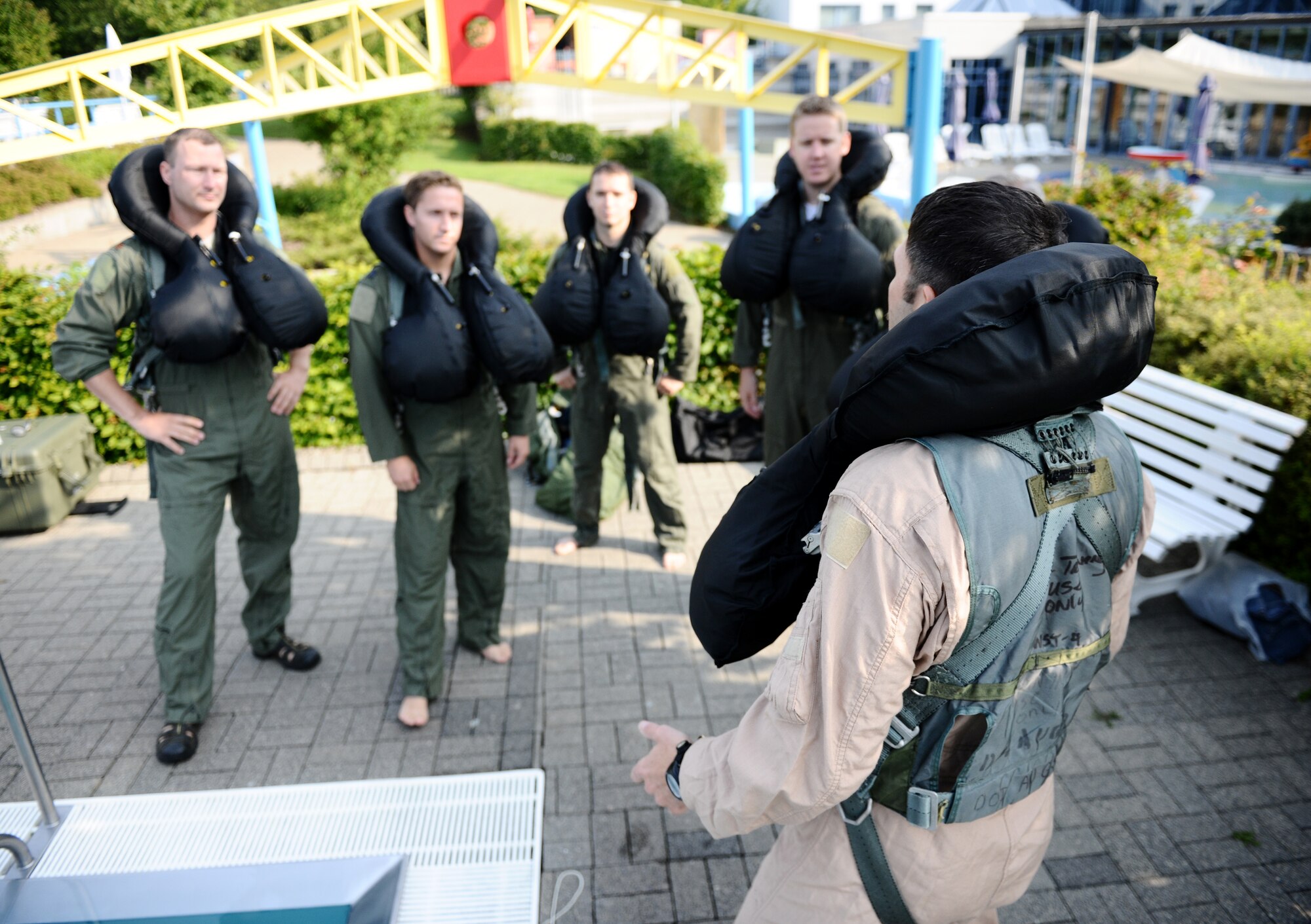 SPANGDAHLEM AIR BASE, Germany -- Tech. Sgt. Robert Martin, foreground, 52nd Fighter Wing Survival, Evasion, Resistance and Escape Training and Operations Survival NCO in charge, explains upcoming training procedures to pilots from the 81st Fighter Squadron prior to water survival training here July 29. Water survival training is a triennial requirement for pilots. (U.S. Air Force photo/Staff Sgt. Nathanael Callon)