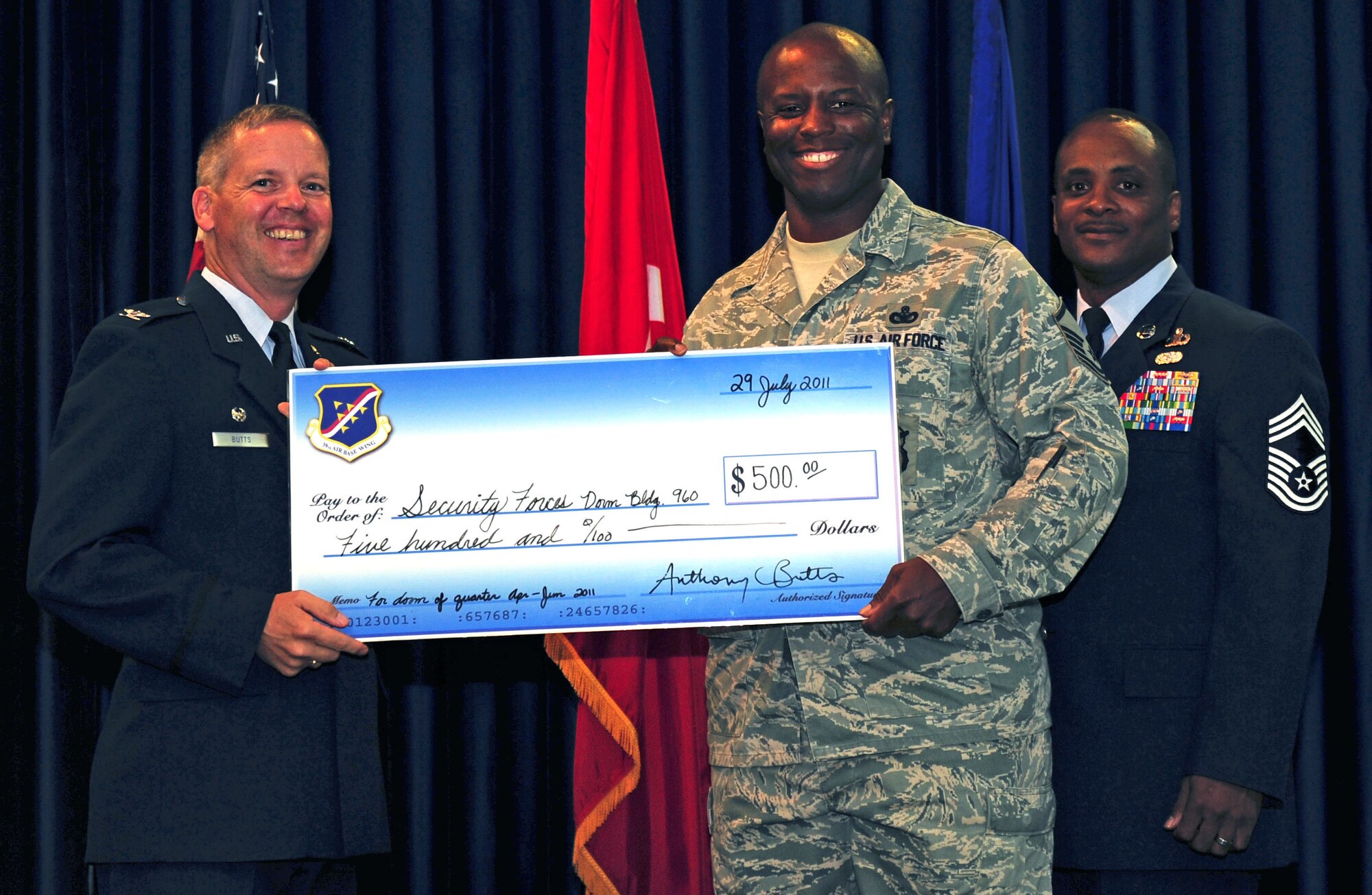Master Sgt. Stephen Boyd, 39th Security Forces Squadron, accepts a check for $500 on behalf of the squadron for receiving the Best Dormitory of the Quarter Award July 29, 2011, at the Club Complex ballroom at Incirlik Air Base, Turkey. (U.S. Air Force photo by Senior Airman Anthony Sanchelli/Released)
