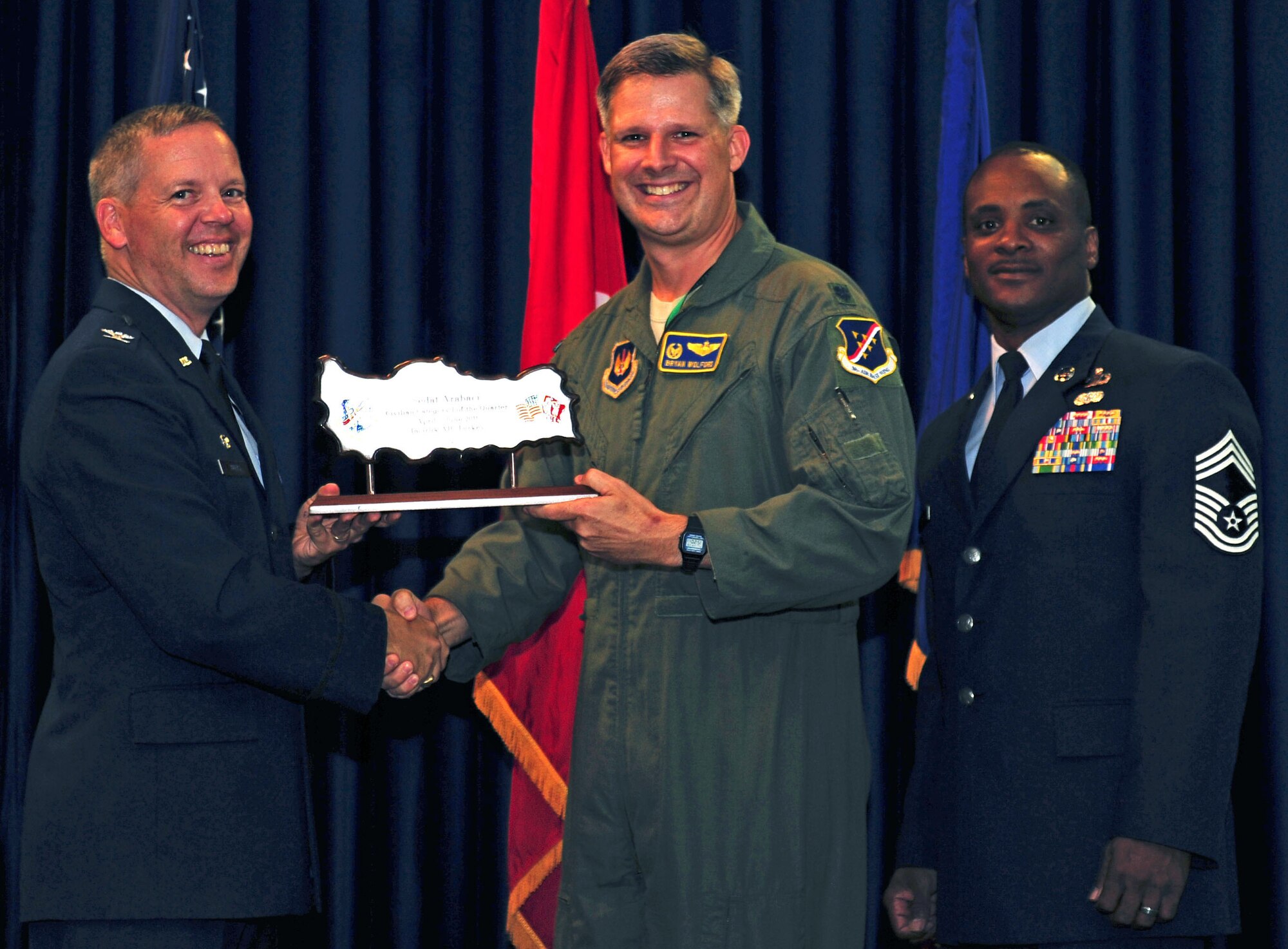 Lt. Col. Bryan Wolford, 39th OS commander, accepts the wing-level Civilian Category One of the Quarter Award on behalf of Sedat Arabaci, 39th Operations Squadron July 29, 2011, at the Club Complex ballroom at Incirlik Air Base, Turkey. (U.S. Air Force photo by Senior Airman Anthony Sanchelli/Released)
