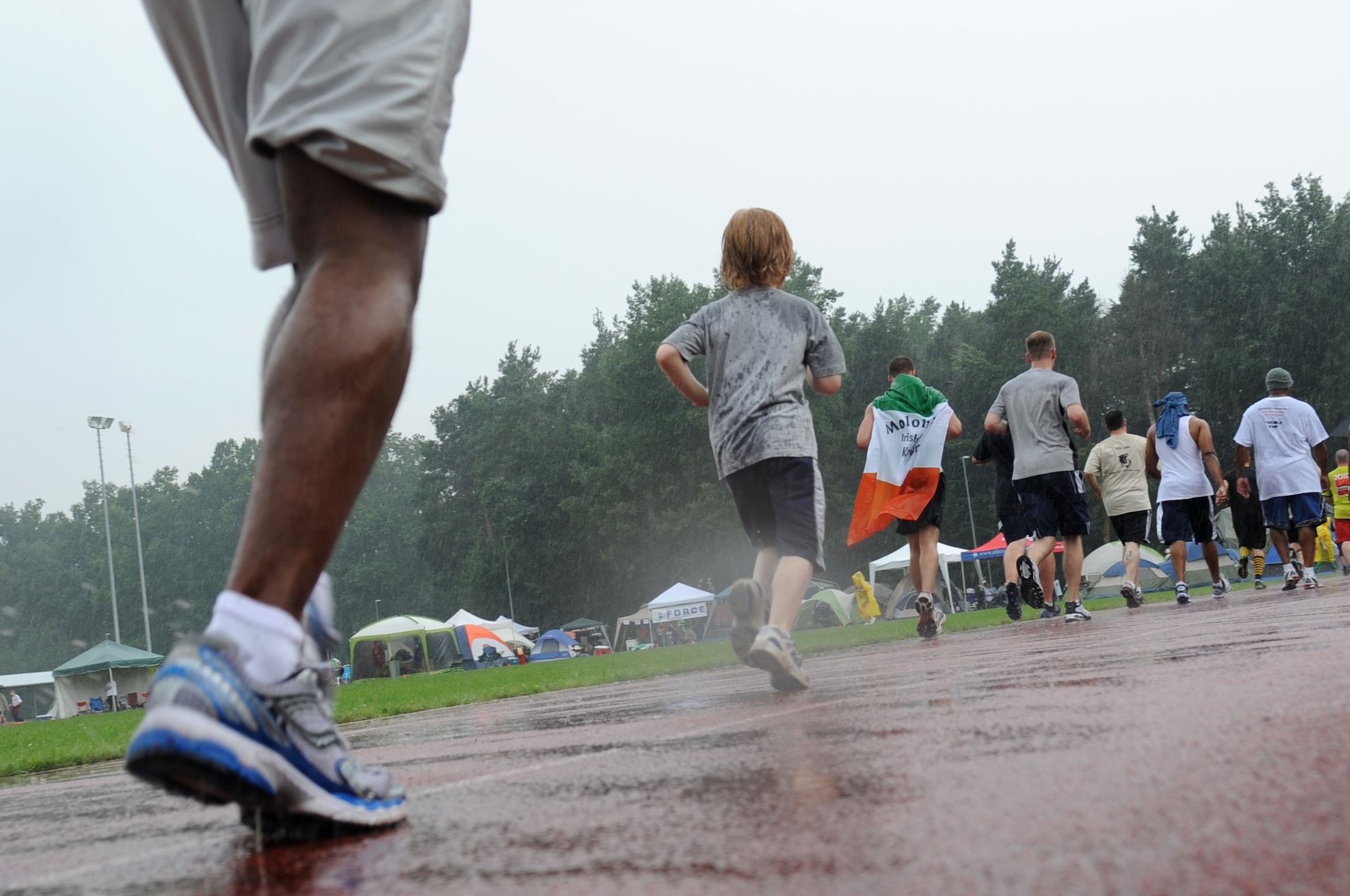 Rain doesn't stop participants from making their way around the track at Pulaski Barracks during the annual KMC Viking Challenge, July 30, 2011. More than 1,000 KMC members took part in the 24-hour event hosted by the KMC 5/6 Club. This year, the club plans to donate funds to both Fisher Houses on Landstuhl Regional Medical Center. (U.S. Air Force photo by Senior Airman Brittany Perry)