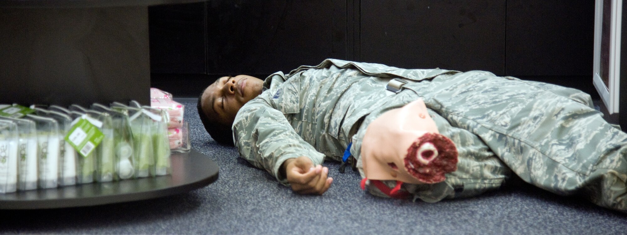 YOKOTA AIR BASE, Japan -- Airman 1st Class Carlaton White, 374th Communications Squadron, plays the role of a wounded casualty during a High Risk Response Training course at Yokota Air Base, Japan, July 27, 2011. The five-day course ended with students responding to scenarios involving live fire simulations, role players and various threats security forces members might face while dealing with an active shooter. (U.S. Air Force photo/Airman 1st Class Krystal M. Garrett)