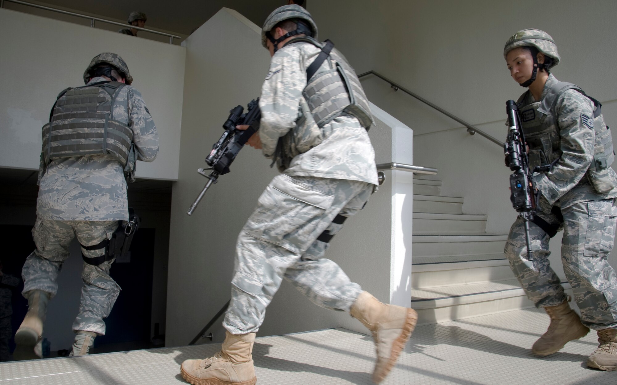 YOKOTA AIR BASE, Japan -- Airmen from the 374th Security Forces Squadron respond to a simulated active shooter scenario inside Yokota's high school July 27, 2011, Yokota Air Base, Japan. The response teams were challenged to react to changing situations quickly and efficiently in an effort to prepare for the unexpected. (U.S. Air Force photo/Senior Airman Andrea Salazar) 