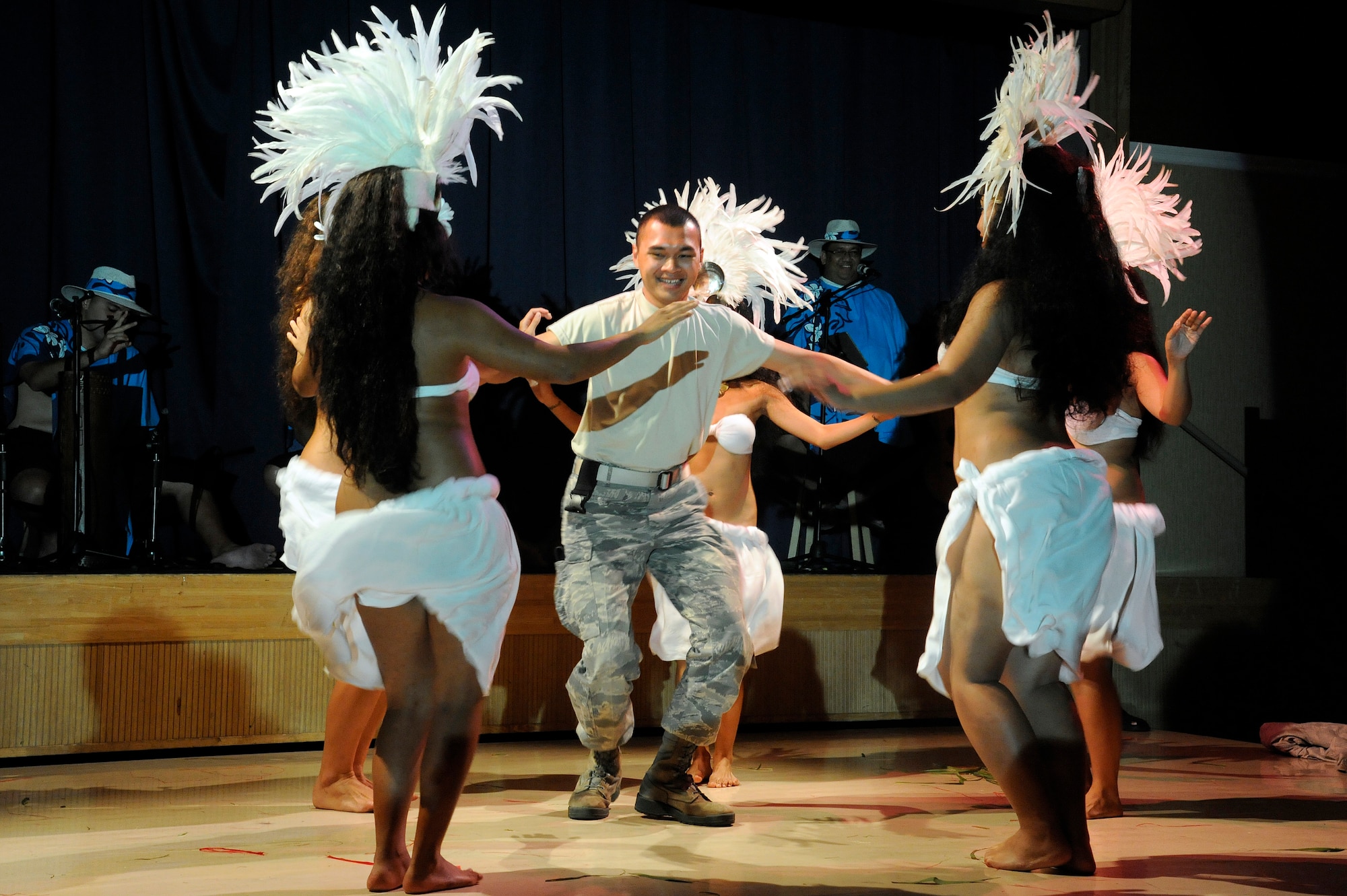 MISAWA AIR BASE, Japan -- Airman 1st Class Jake Ngiraked, center, 35th Security Forces Squadron, dances with the female dancers of Ma'ohi Nui during a luau at the Misawa Collocated Club July 29. Audience members were chosen by Ma'ohi Nui dancers for a Hula 101 lesson at the end of the night. (U.S. Air Force photo/Staff Sgt. Marie Brown/Released)
