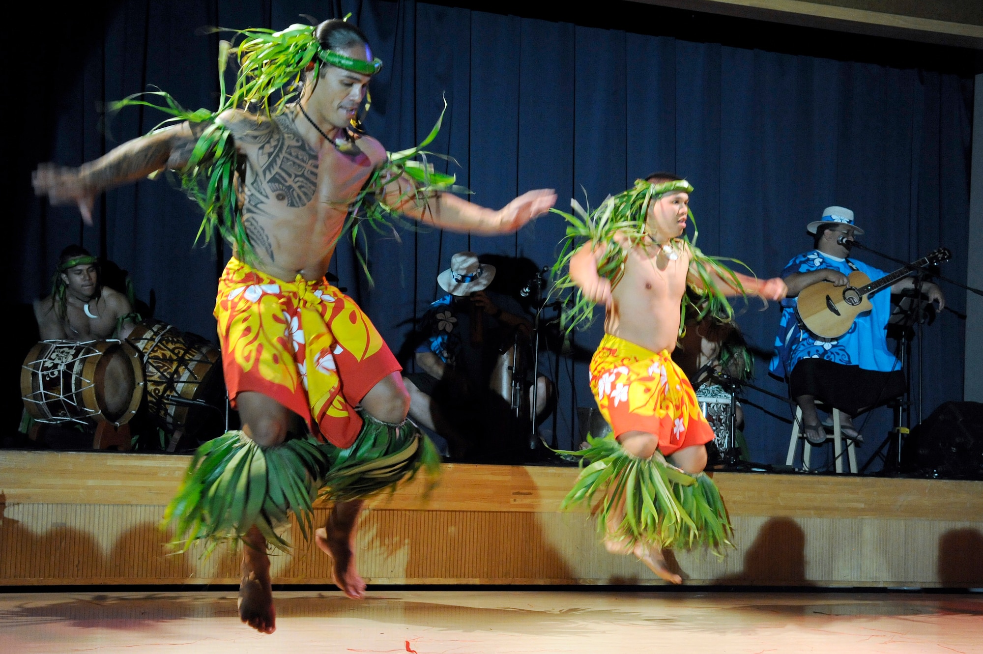 MISAWA AIR BASE, Japan -- Mervyn Lilo, left, the lead male dancer for Ma'ohi Nui, and Jon Makakoa Ulibas perform for members of the Misawa community during a luau at the Misawa Collocated Club July 29. Ma'ohi Nui performed at the club as part of an Armed Forces Entertainment show to show their support for military families overseas. (U.S. Air Force photo/Staff Sgt. Marie Brown/Released)