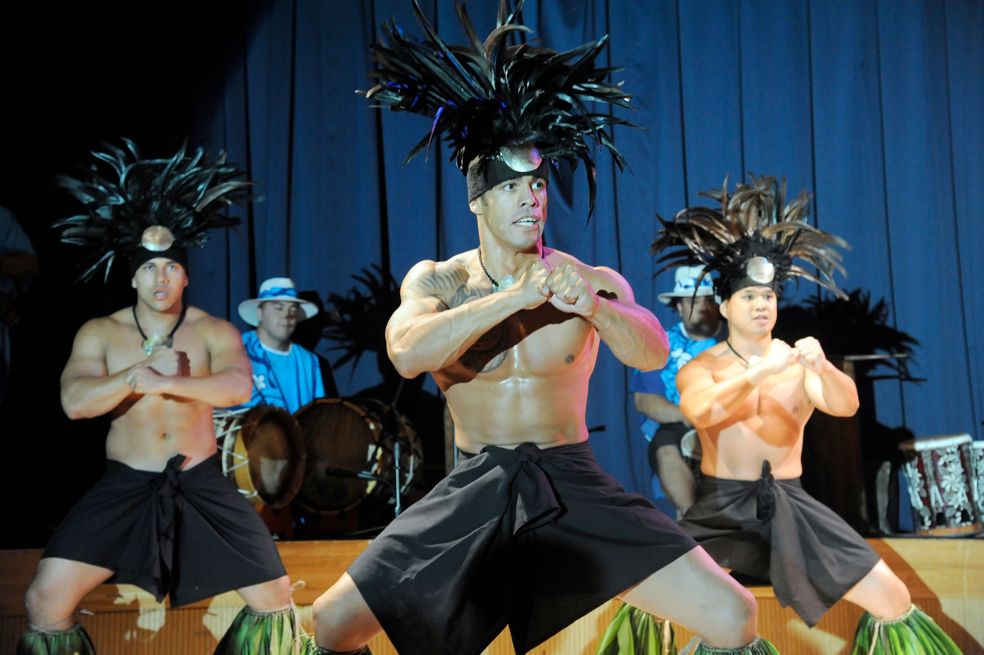 MISAWA AIR BASE, Japan -- Mervyn Lilo, front, the lead male dancer for Ma'ohi Nui, performs with other members of Ma'ohi Nui during a luau at the Misawa Collocated Club July 29. Ma'ohi Nui performed for Team Misawa during a two-hour show at the club. (U.S. Air Force photo/Staff Sgt. Marie Brown/Released)