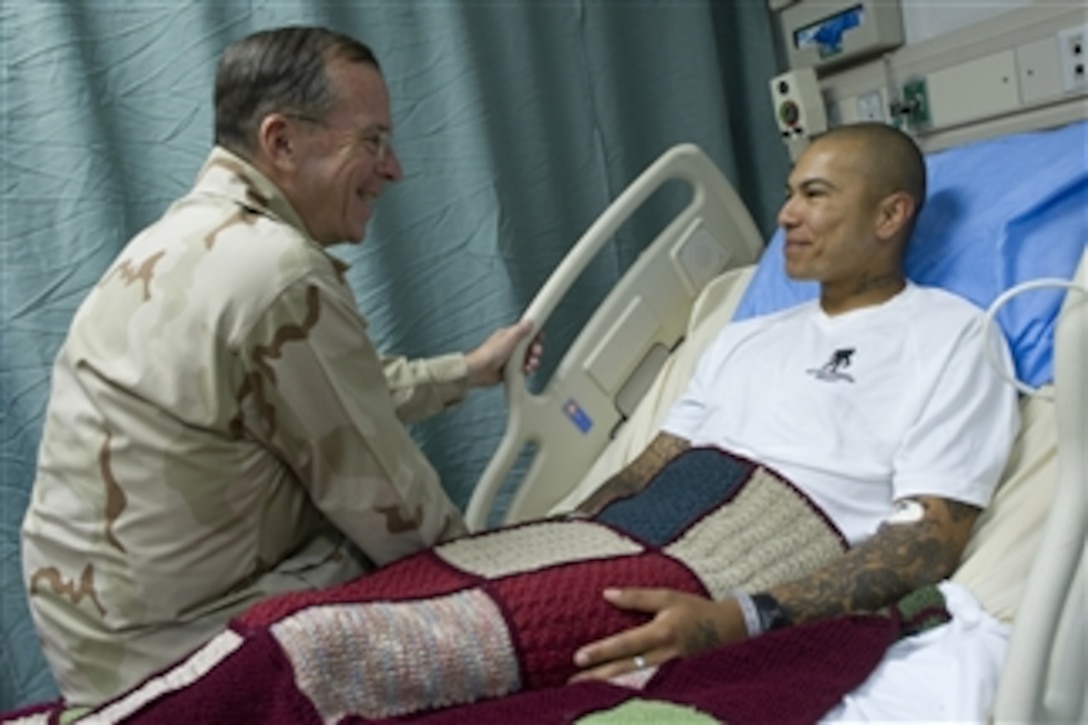 Chairman of the Joint Chiefs of Staff Adm. Mike Mullen visits with U.S. Army Spc. Rosasgarza Francisco, a patient at Craig Joint Theater Hospital at Bagram Airfield, Afghanistan, on Aug. 1, 2011.  Mullen is on a five-day USO tour with comedian Jon Stewart, NBA legend Karl Malone and magician David Blane visiting troops in Afghanistan and Iraq.  