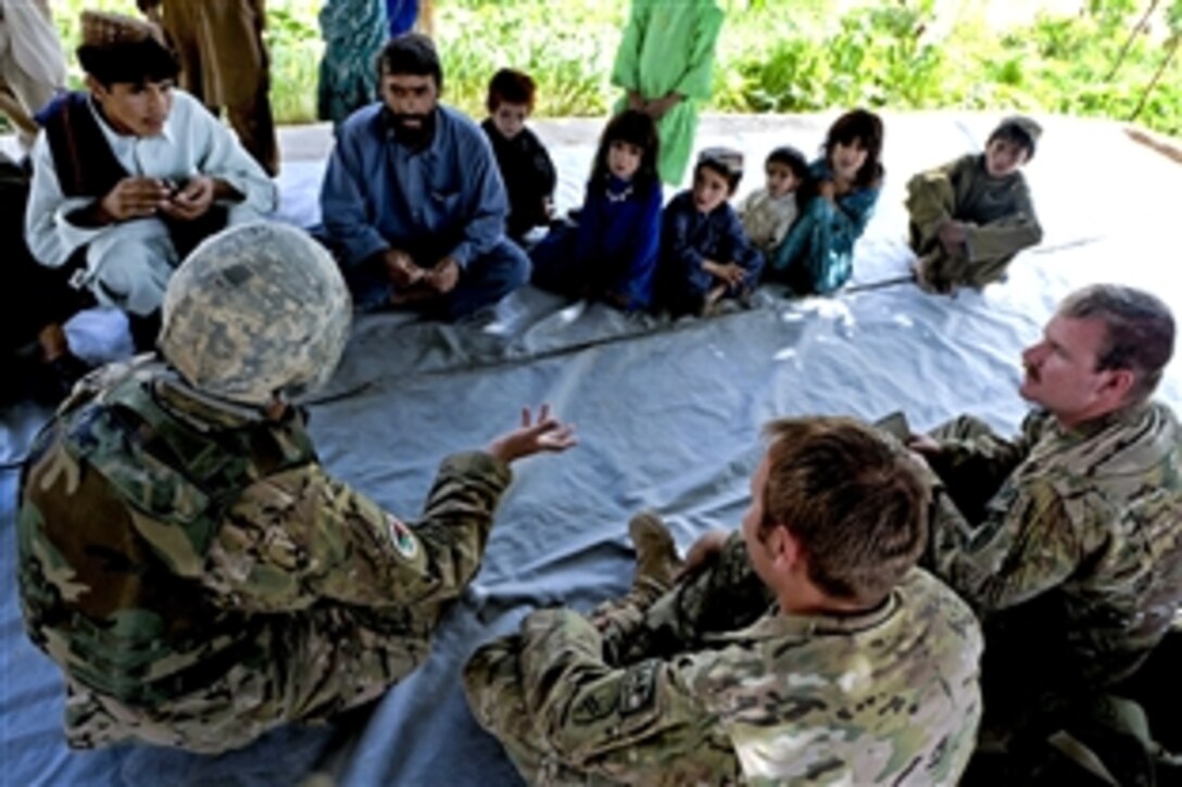 Members of Provincial Reconstruction Team Zabul conduct a key leader engagement with village elders in Arghandab, Zabul province, Afghanistan, July 30, 2011. The team works to conduct civil-military operations aimed at extending the reach and legitimacy of the Afghan government.