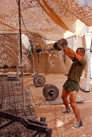 Lance Cpl. Jose Contreras completes a kettle bell swing as part of the Rankel Workout here, Aug. 1. Contreras, a native of San Antonio, is a team leader with Charlie Company, 1st Battalion, 3rd Marine Regiment. The Rankel workout is dedicated to Sgt. John Rankel, who died while deployed here in 2010.