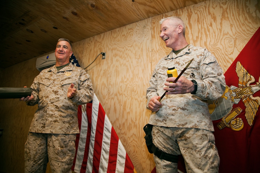 U.S. Marine Corps Maj. Gen. John A. Toolan, the commanding general of Regional Command Southwest, speaks to members of 2nd Marine Aircraft Wing (Forward), prior to promoting Maj. Gen. Glenn M. Walters, the wing's commanding general, to his current rank at Camp Leatherneck, Afghanistan, August 2. In Afghanistan, Walters leads the aviation combat element in support of NATO International Security Assistance Force’s Regional Command Southwest.