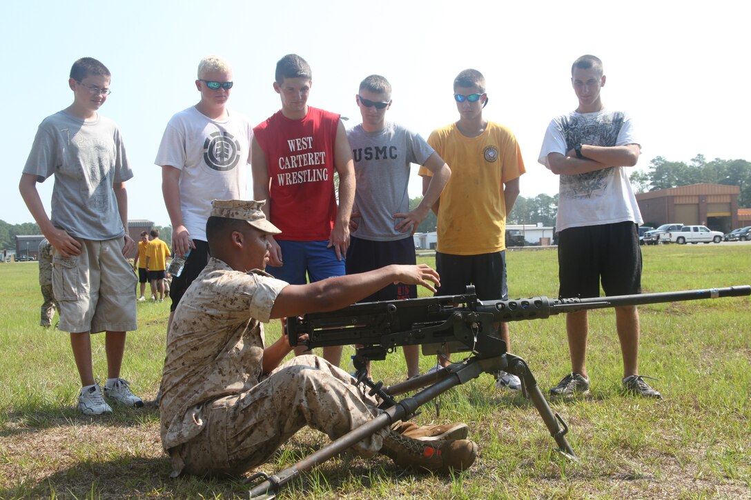 Cpl. Timothy A. Loper, a gunner for the 2nd Low Altitude Air Defense Battalion, demonstrates the operation of the M2 Browning .50 caliber machine gun to Navy Junior Officer Training Corps cadets.