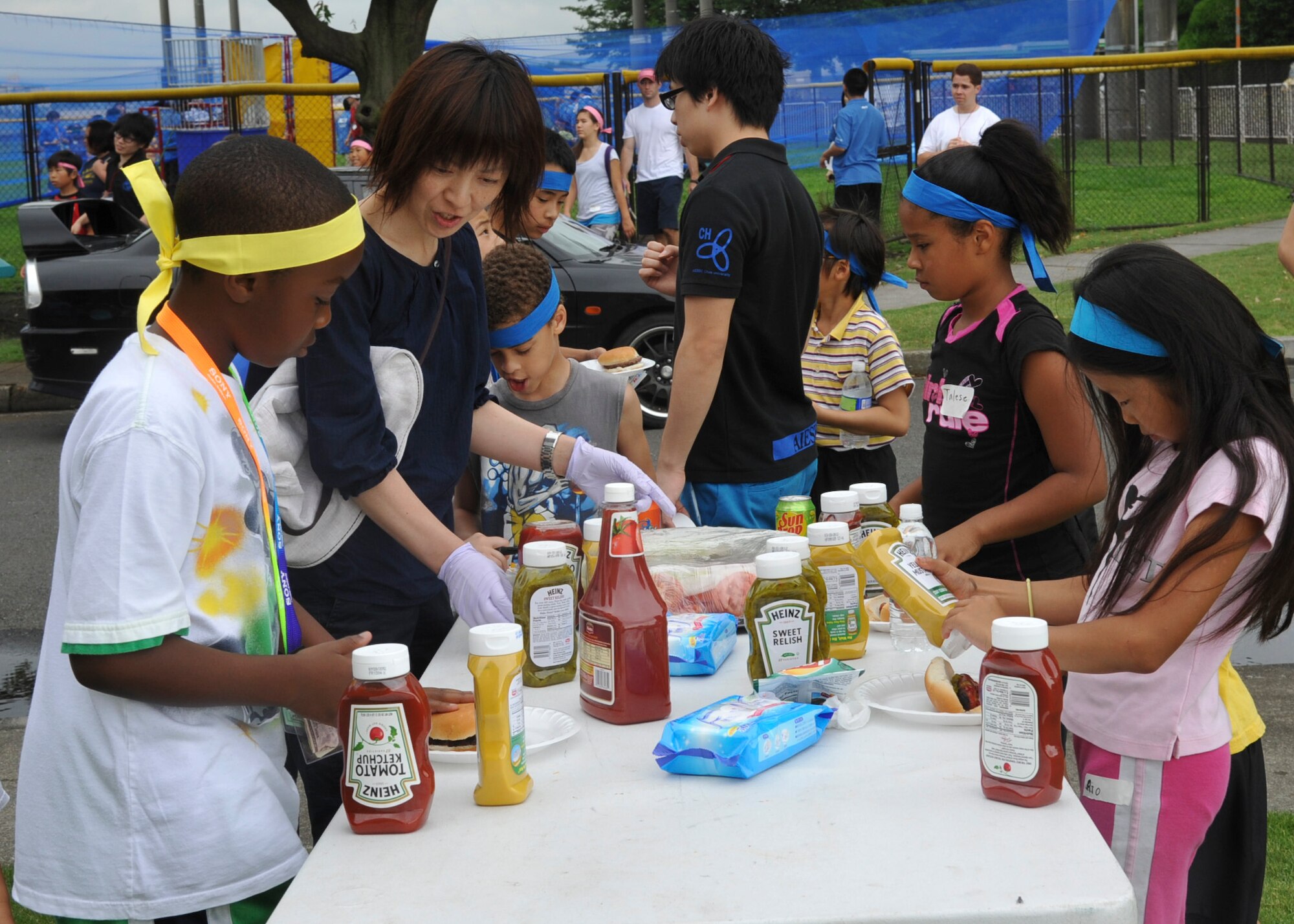 YOKOTA AIR BASE, Japan -- Japanese and American children prepare lunch during the conclusion of a cultural friendship barbeque at Yokota Air Base, Japan, July 30, 2011. The event provided an opportunity for Japanese and Yokota children to interact with each other while promoting the relationship between the base and surrounding communities. (U.S. Air Force photo/Senior Airman Andrea Salazar)