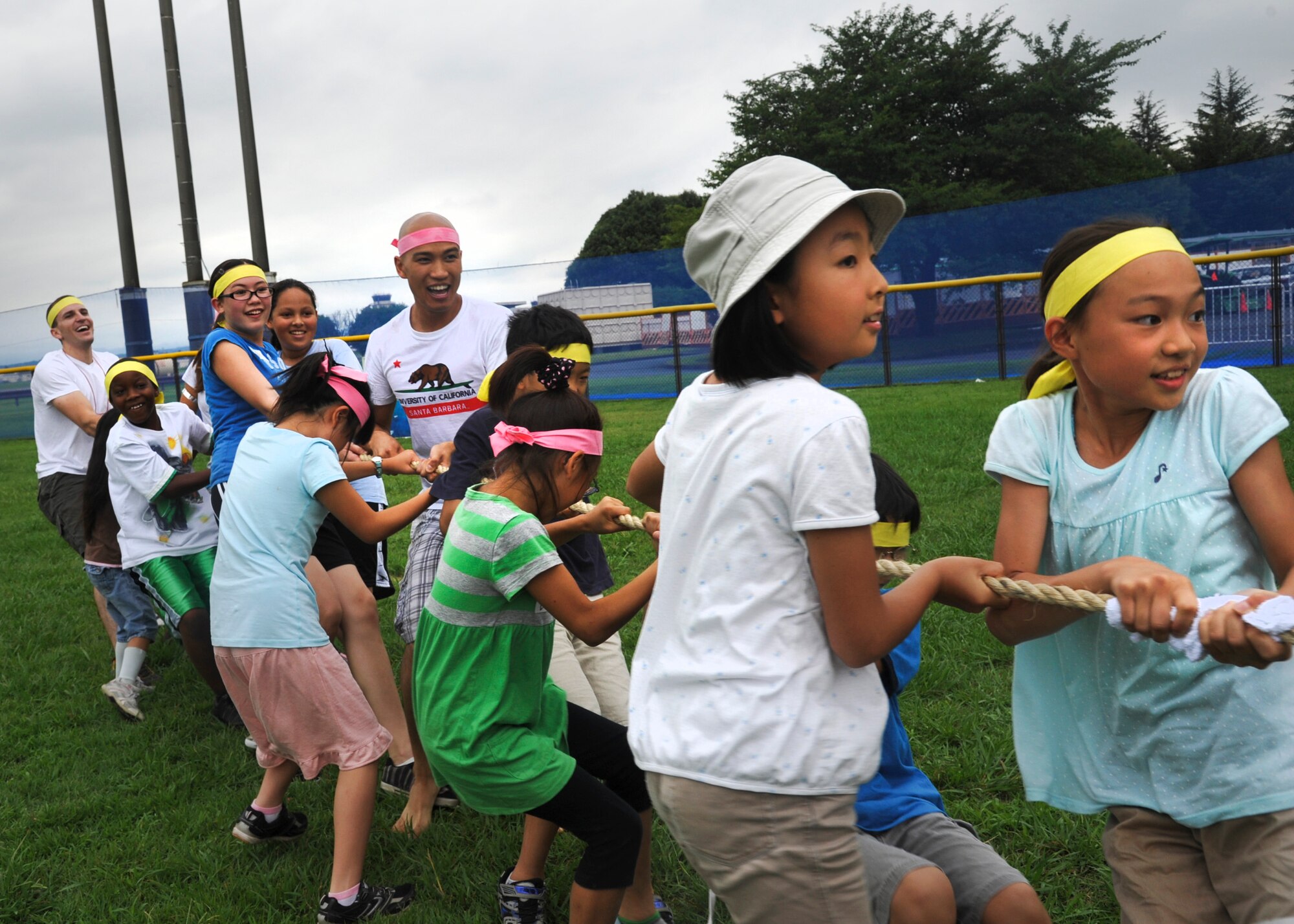 YOKOTA AIR BASE, Japan -- Japanese and American children, along with members of Yokota's Company Grade Officer Council, participate in tug-of-war games during a cultural friendship barbeque at Yokota Air Base, Japan, July 30, 2011. The event was hosted by the CGOC, Youth Center and Joint Chamber International Japan as a chance for children to have fun while sharing each other's cultures. (U.S. Air Force photo/Senior Airman Andrea Salazar)