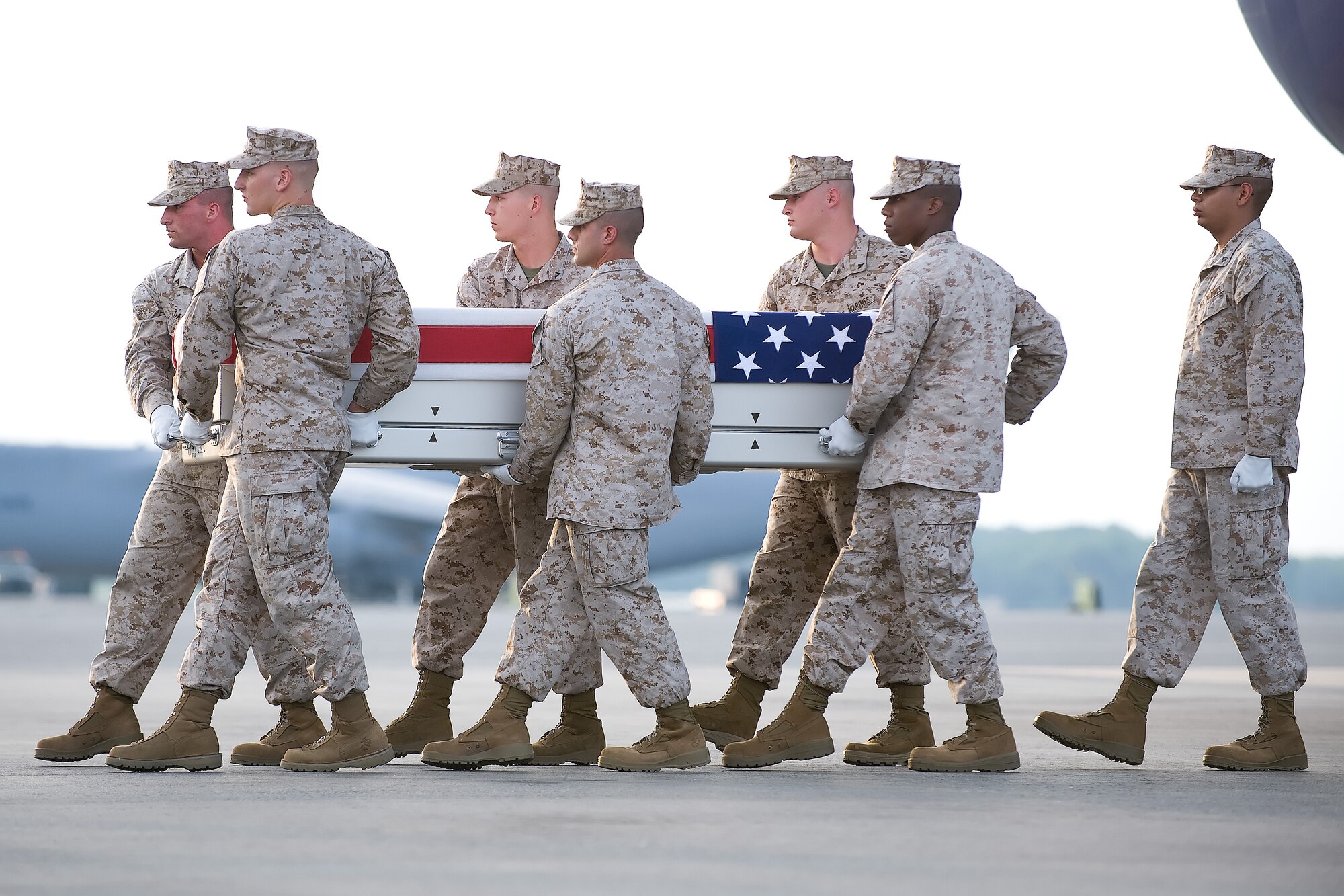 A U.S. Marine Corps carry team transfers the remains of Marine Sgt. Christopher M. Wrinkle of Stewartstown, Pa., at Dover Air Force Base, Del., Aug. 2, 2011. Wrinkle was  assigned to 2nd Marine Special Operations Battalion, Marine Special Operations Regiment, U.S. Marine Corps Forces Special Operations Command, Camp Lejeune, N.C. (U.S. Air Force photo/Adrian Rowan)