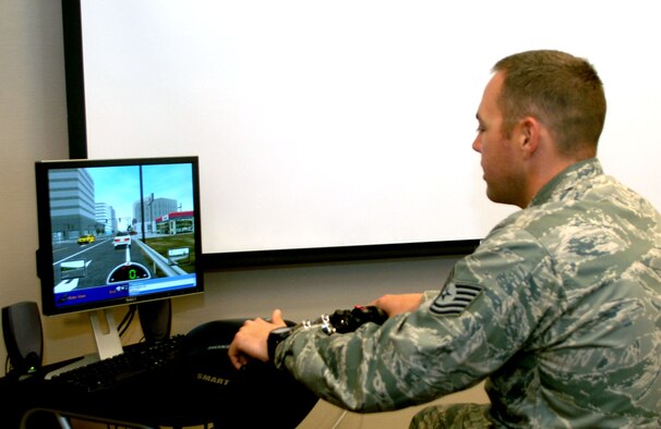 Tech. Sgt. Shane Christian, 28th Civil Engineer Squadron ground safety NCO in charge, tests his motorcycle riding ability using the motorcycle simulator, at Ellsworth Air Force Base, S.D., July 27, 2011.  The simulator was made available to Ellsworth Airmen as a training tool for increased motorcycle safety.  (U.S. Air Force photo/Airman Alessandra N. Gamboa/Released)