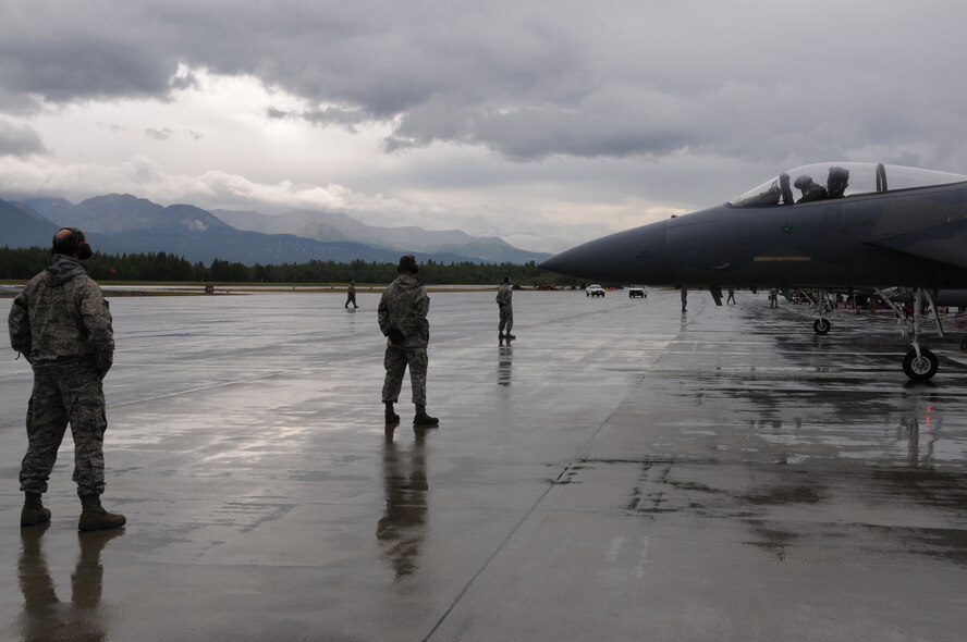 Crew chiefs from the 104th Fighter Wing, Massachusetts Air National Guard await the launch of their aircraft.  While deployed to Joint Base Elmendorf-Richardson, Alaska they are supporting a joint training exercise.  (U.S.A.F. photograph by Technical Sergeant, Anthony M. Mutti)