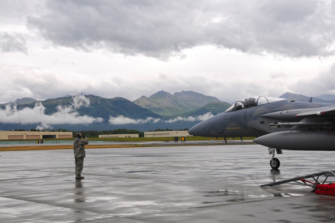 TSgt. Cliff Daley, 104th Fighter Wing crew chief, salutes the pilot of an F-15 as it departs Joint Base Elmendorf-Richardson, Alaska for a training mission. (U.S. Air Force Photo by: Technical Sergeant, Anthony M. Mutti)