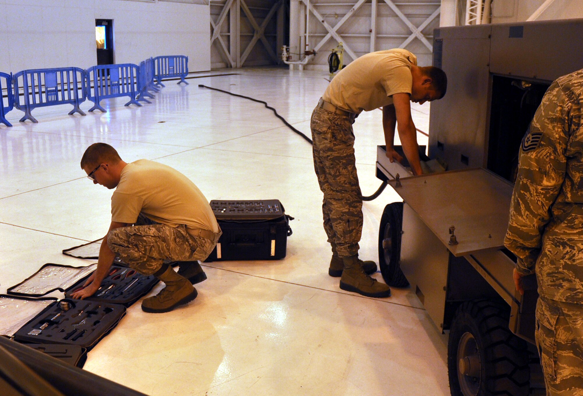 Senior Airman Mitchell Tindal and Staff Sgt. Jason Kopenhafer, 92nd Maintenance Squadron, repair a generator during the maintenance skills compeition, 2011 Air Mobility Rodeo, Joint Base Lewis-McChord July 28. They were part of a four-man maintenance team which had a total of 30 minutes to complete the challenge. The team made their time with 32 seconds to spare. (U.S. Air Force Photo/Tech. Sgt. Jennifer Buzanowski)