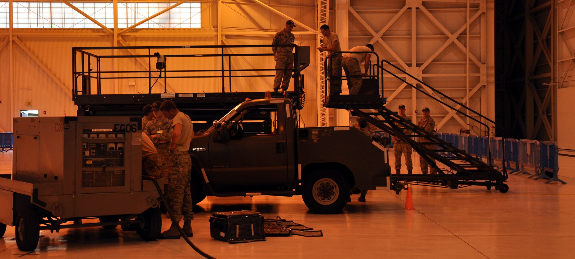 The four-man Fairchild maintence team competes in the 2011 Air Mobility Rodeo Maintenance skills compeition July 28 at Joint Base Lewis-McChord. Bottom, two 92nd Maintenance Squadron Airmen work to repair a generator and top, two 92nd Aircraft Maintenance Squadron Airmen work to change out values on a simulated aircraft. The team finished under the 30 minute time limit and earned two bonus points during their competition. Fellow maintainers, 92nd Air Refueling Wing leadership and Spokane-area civic leaders cheered on the team. (U.S. Air Force Photo/Tech. Sgt. Jennifer Buzanowski)