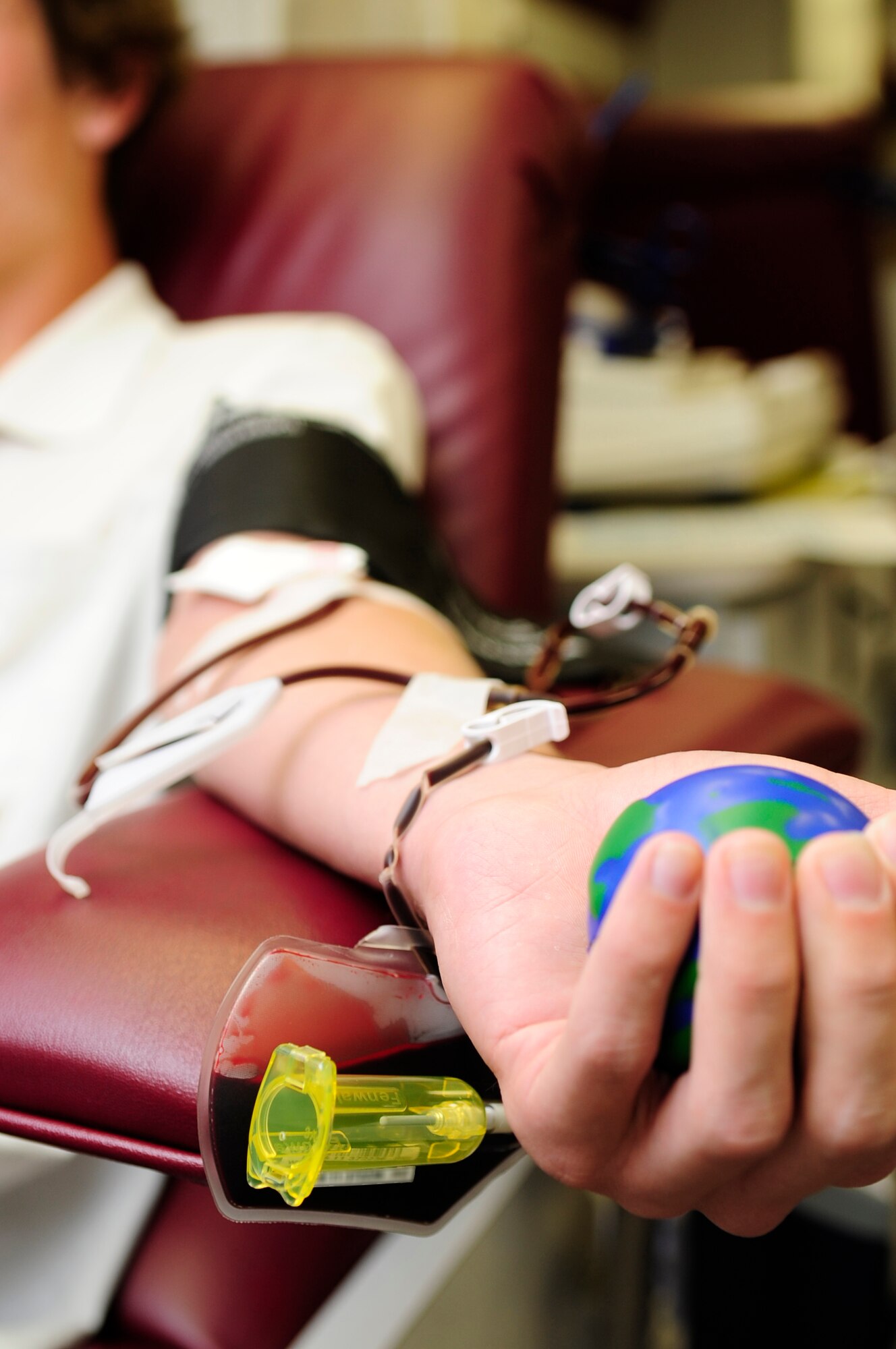 VANDENBERG AIR FORCE BASE, Calif. – Phillip Draeger, a Commissary bagger, donates blood during the United Blood Services blood drive at the Headquarters Building parking lot here Tuesday, July 26, 2011. Mr. Draeger is a recent graduate of Cabrillo High School and has been donating blood to the UBS for about two years. (U.S. Air Force photo/Senior Airman Lael Huss)