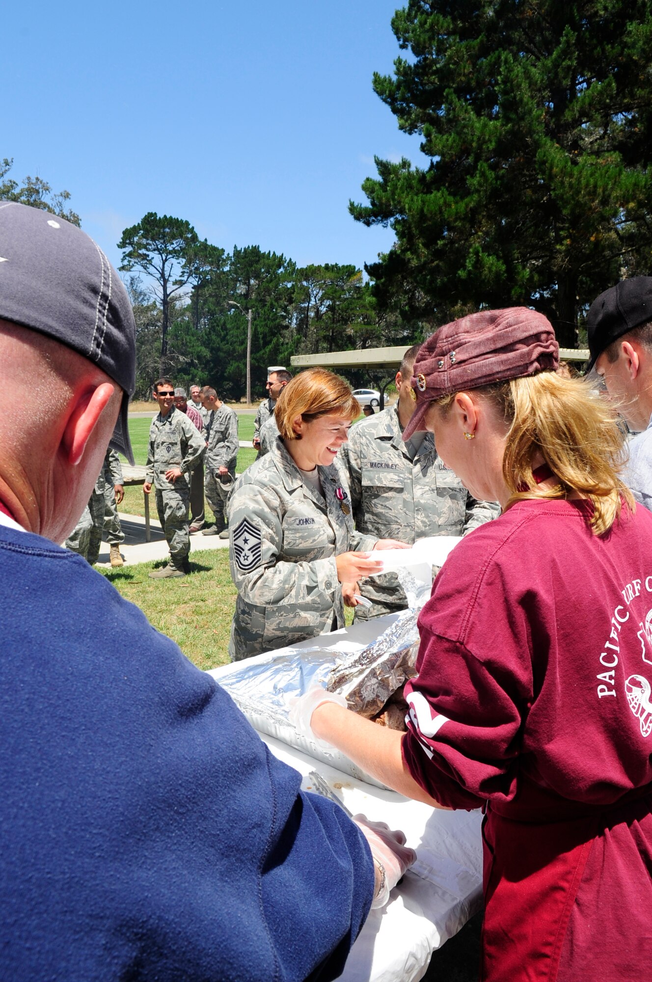 VANDENBERG AIR FORCE BASE, Calif. – Vandenberg’s Non-Commissioned Officer Association prepare a meal at the going away picnic for Chief Master Sgt. Angelica Johnson, the former 30th Space Wing command chief, here Thursday, July 28, 2011. The NCOA provided grilled chicken, tri-tip, beans, salad and bread.  (U.S. Air Force photo/Senior Airman Lael Huss)