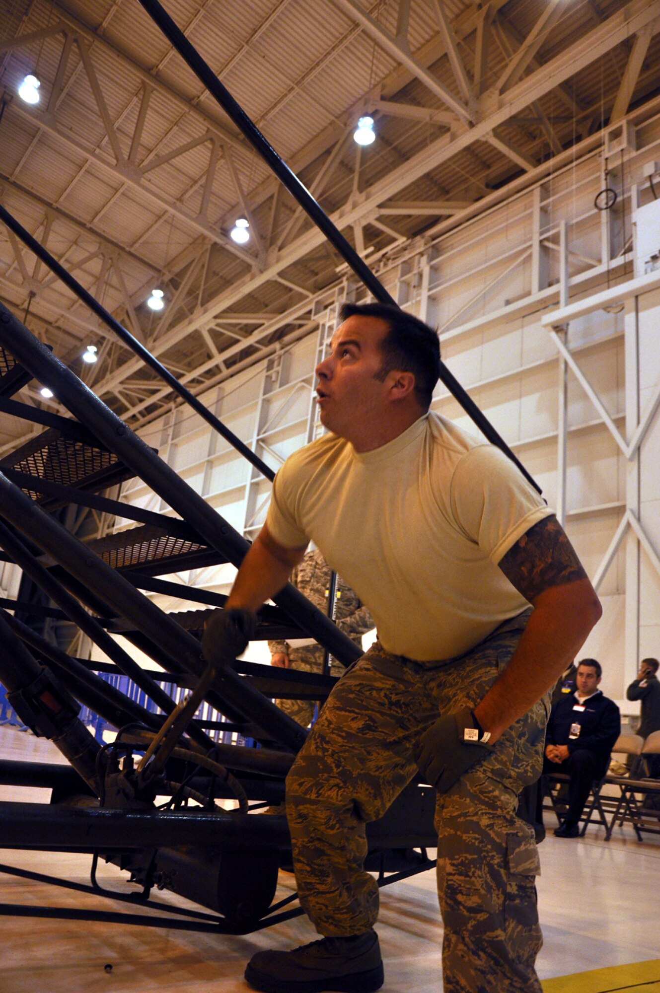 Staff Sgt. Derrick Brooke, 92nd Aircraft Maintenance Squadron KC-135 crew chief, looks to the challenge of changing out a simulated defective value as he secures the wheels on a portable stairwell. He was one of a four-man team compeiting in the maintenance skills compeition July 28 as part of the Air Mobility Rodeo, Joint Base Lewis-McChord. (U.S. Air Force Photo/Tech. Sgt. Jennifer Buzanowski)
