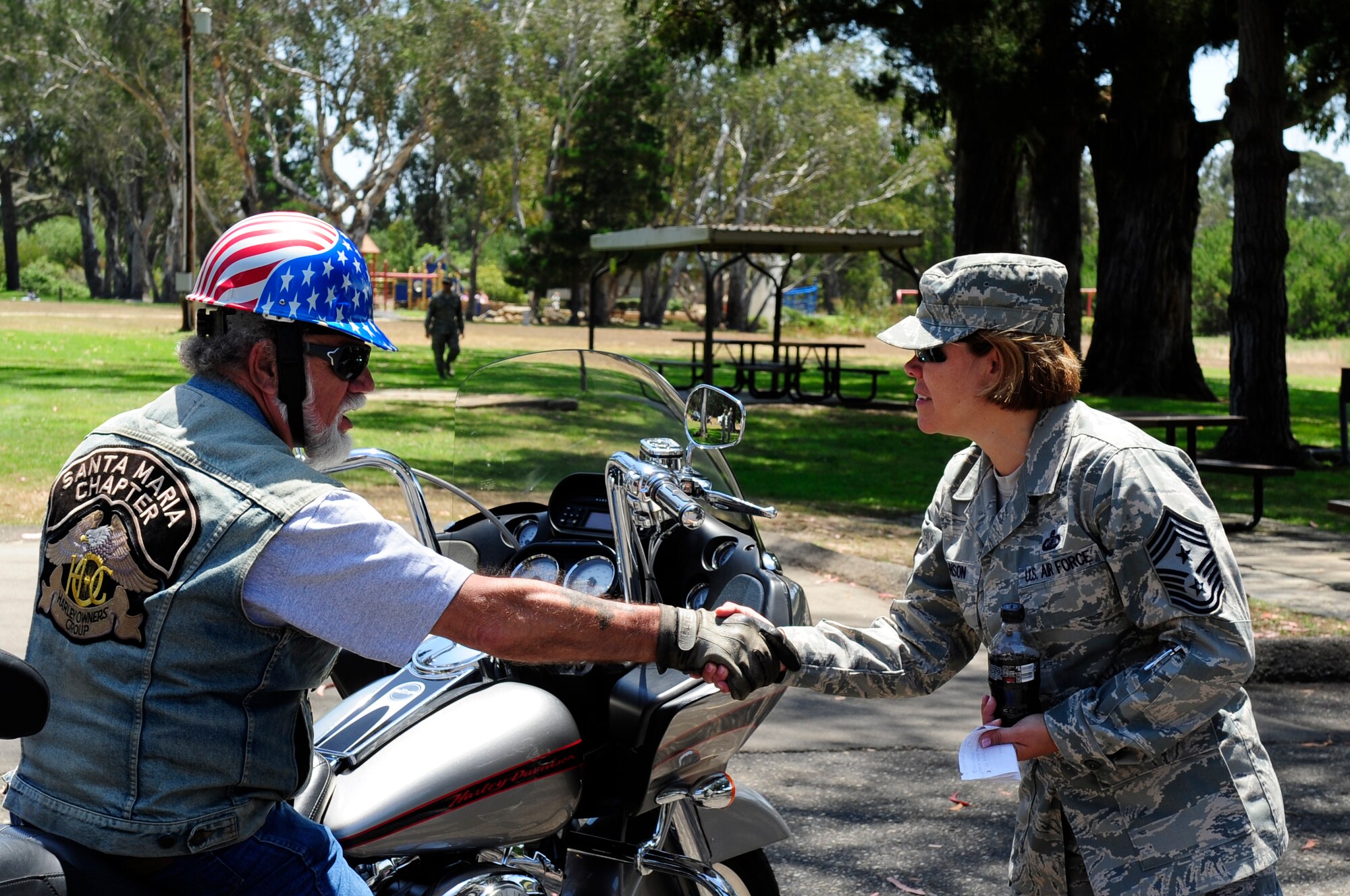 VANDENBERG AIR FORCE BASE, Calif. – Members of the Nation of Patriots Tour surprise Chief Master Sgt. Angelica Johnson, the former 30th Space Wing command chief, by driving by her going away barbeque at Cocheo Park here Thursday, July 28, 2011. The Patriot Tour travels the U.S. with an American flag to 48 states over 100 days. (U.S. Air Force photo/Senior Airman Lael Huss)