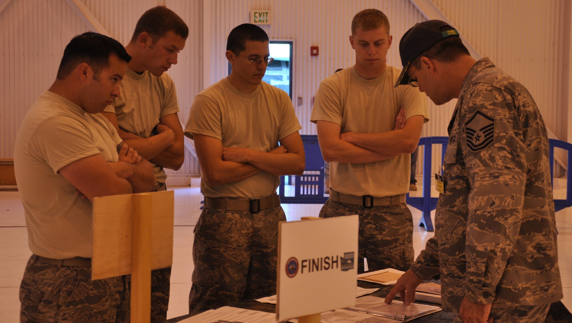Master Sgt. John Broome, a maintenance umpire for the 2011 Air Mobility Rodeo at Joint Base Lewis-McChord, briefs the Fairchild Airmen competing in the maintenance skills competition. From left, Staff Sgt. Derrick Brooke, 92nd Aircraft Maintenance Squadron KC-135 crew chief; Staff Sgt. Jason Kopenhafer, 92nd Maintenance Squadron structural maintenance specialist; Staff Sgt. Robert Valdez, 92nd AMXS aerospace propulsion specialist; and Senior Airman Mitchell Tindal, 92nd MXS aerospace ground equipment specialist, listen to the rules of the compeition which included a 30-minute time limit. (U.S. Air Force Photo/Tech. Sgt. Jennifer Buzanowski)