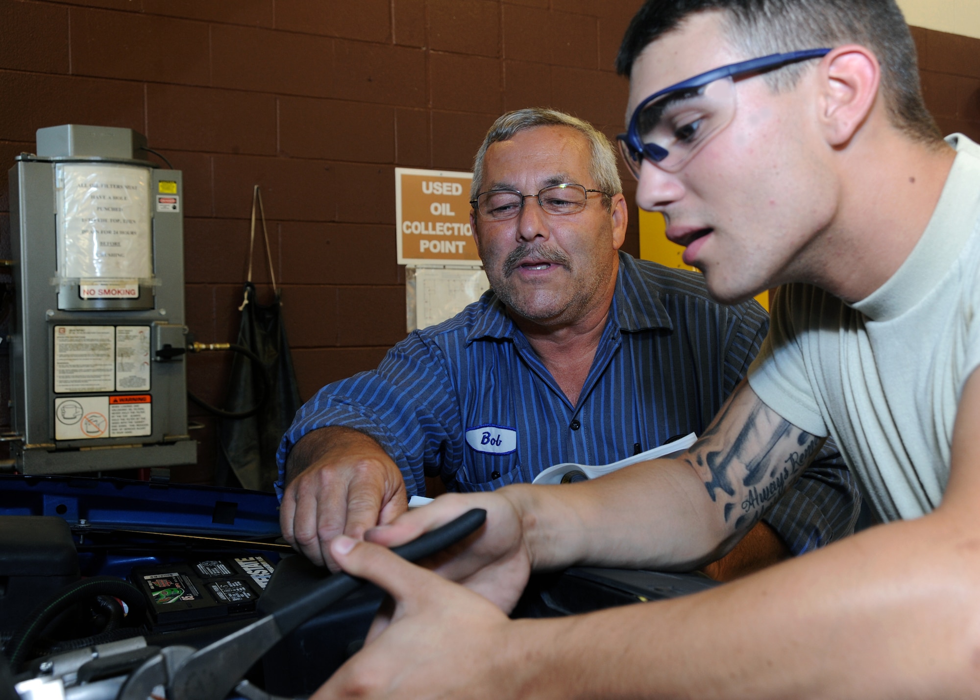 Bob Bergeron, 319th Logistic Readiness Squadron, instructs Airman 1st Class William Damico, 319th LRS, on vehicle maintenance training procedures August 2, 2011, on Grand Forks Air Force Base, N.D.  Warrior of the Week recognizes everyday airman working their every day jobs.  (U.S. Air Force photo by Senior Airman Amber Bennett)